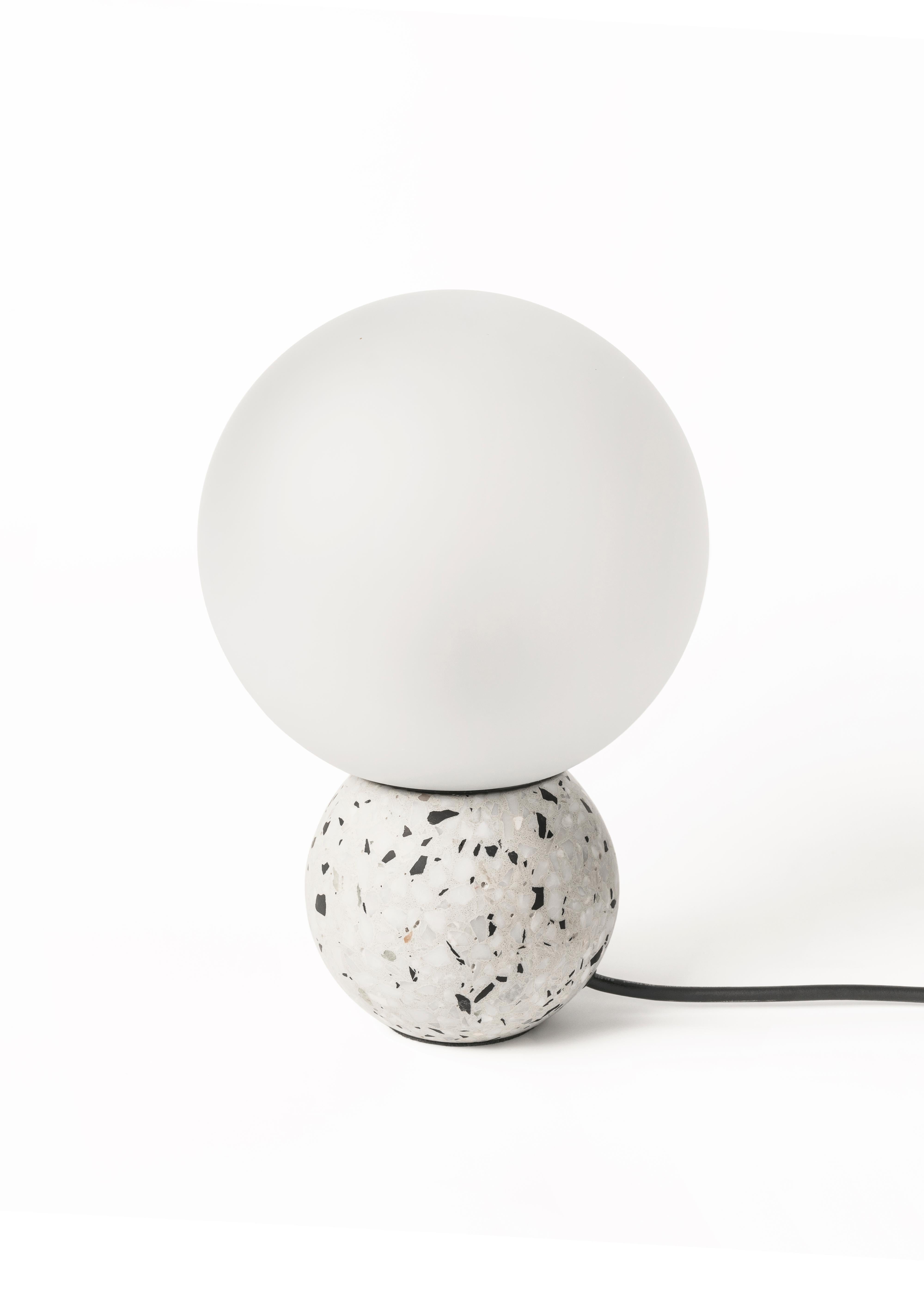 '8' table lamp in terrazzo (Black / White)

Measures: Ø20 cm × H 29.5 cm

Bulb: E27 LED 3W 100-240V 80Ra 200LM 3000K - Comptable with US electric system.

Bentu Design furniture and lightings derive its uniqueness from the simplicity of its forms