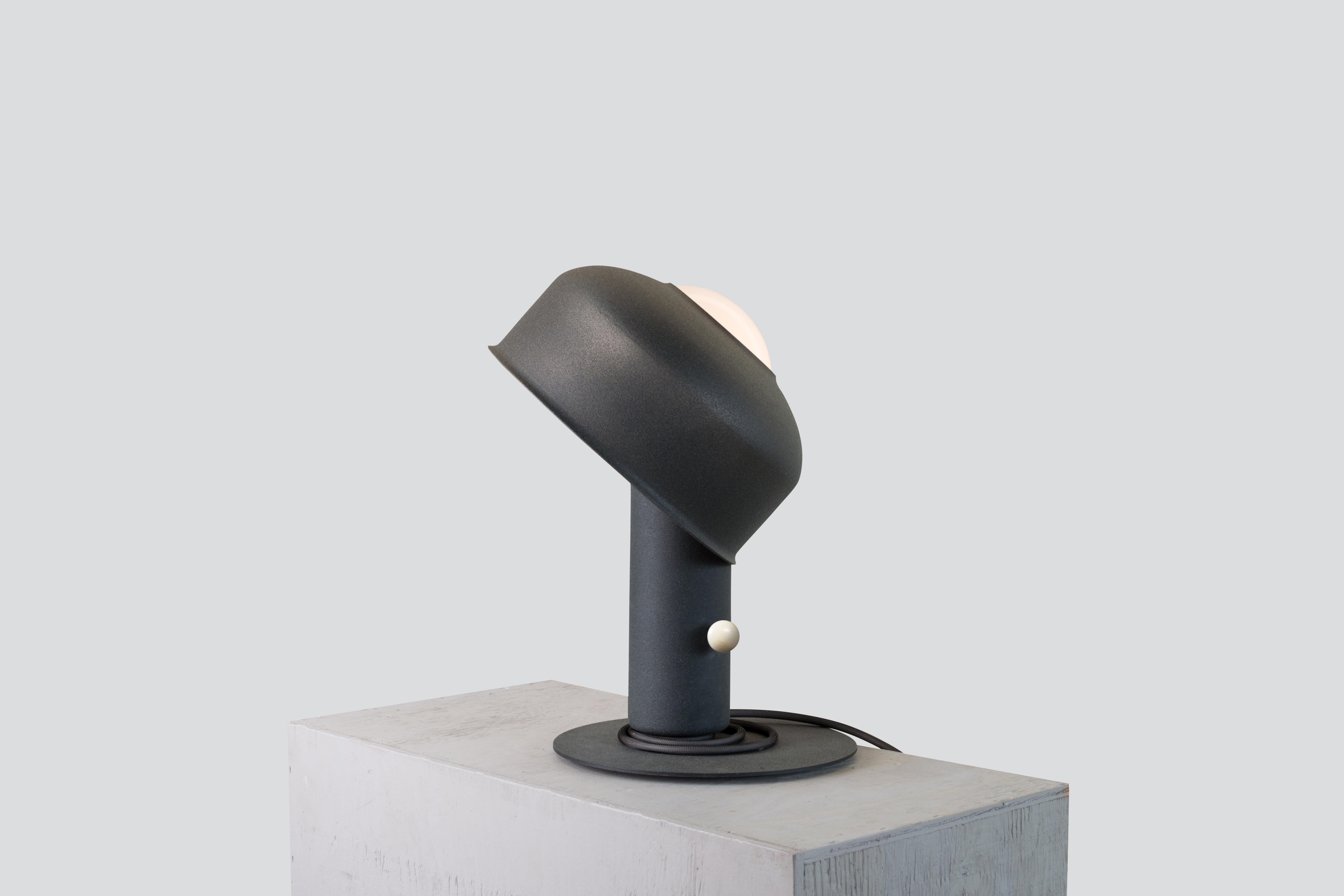 Pivot, table lamp
Design: Lukas Peet, Editor: AND Light

The Pivot table luminaire is playful and interactive as its balancing shade allows for easy adjustments.

Materials:
– Steel
– Aluminum 
– Glass

Dimensions:
380 x 280 x 280mm / 15”