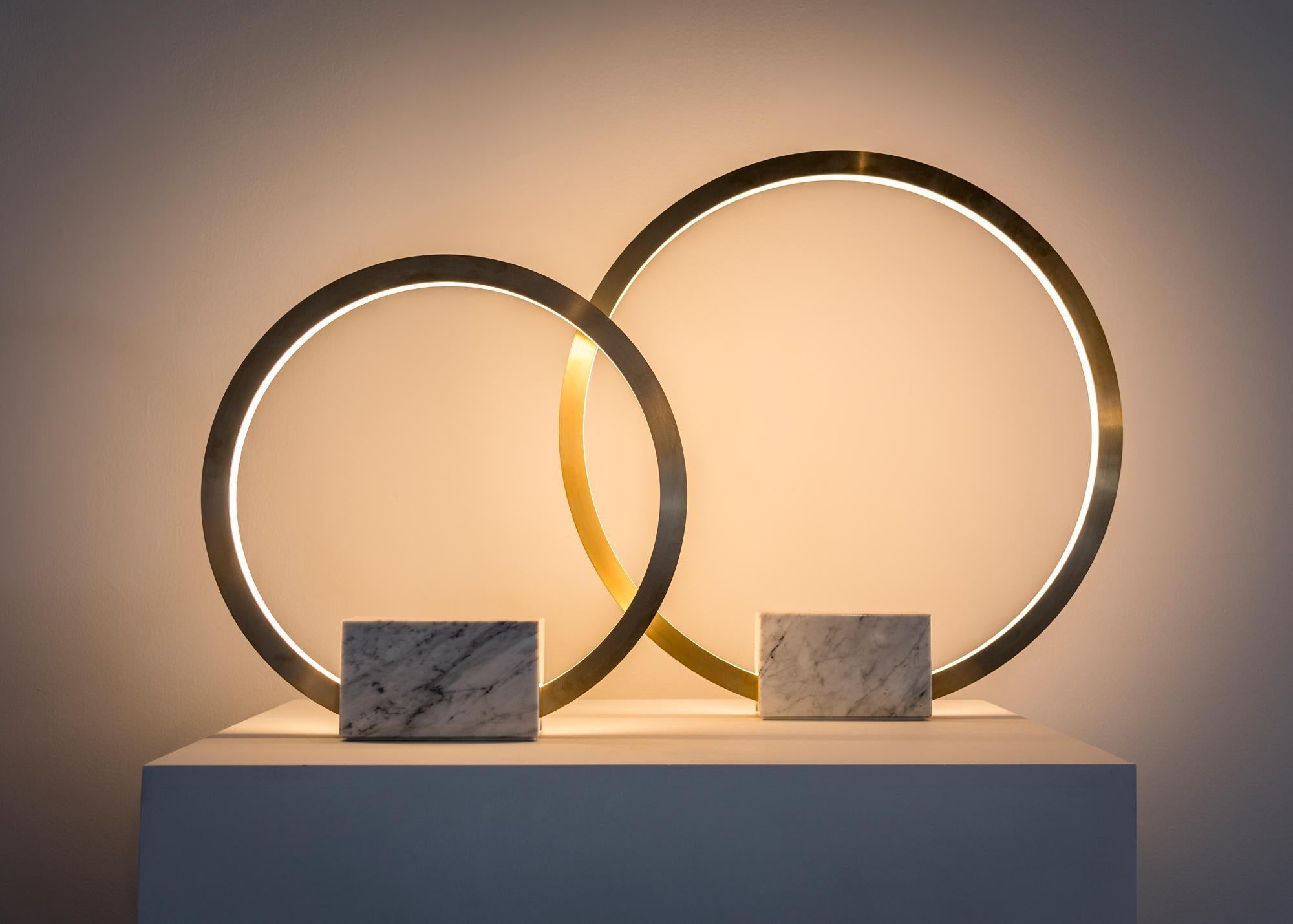 Contemporary table light in brass with marble base, Portal 450 by Christopher Boots

Emanating luminescence from a minimalist form, PORTAL TABLE LAMP embodies the cyclical nature of existence.

Looking through PORTAL TABLE LAMP one is drawn