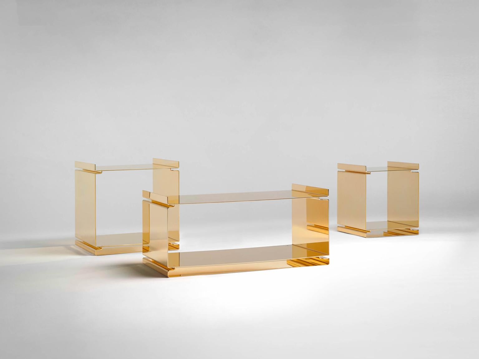 SEM Gold collection, low tables of interlocking steel elements. Plated in 24-karat polished yellow gold. Set of three: W 30 x D 30 x H 35, W 40 x D 40 x H 40, W 70 x D 35 x H 30 cm. The Gold collection has a range of exemplary pieces that echo the