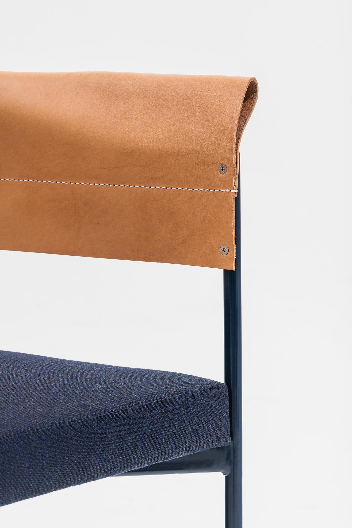 Armchair made with a thin and elegant hand-welded steel frame whose curvature supports the precious leather, folded and sewn to act as a backrest and the same time as an armrest. Available in red, blue, black structure as per the full grain leather