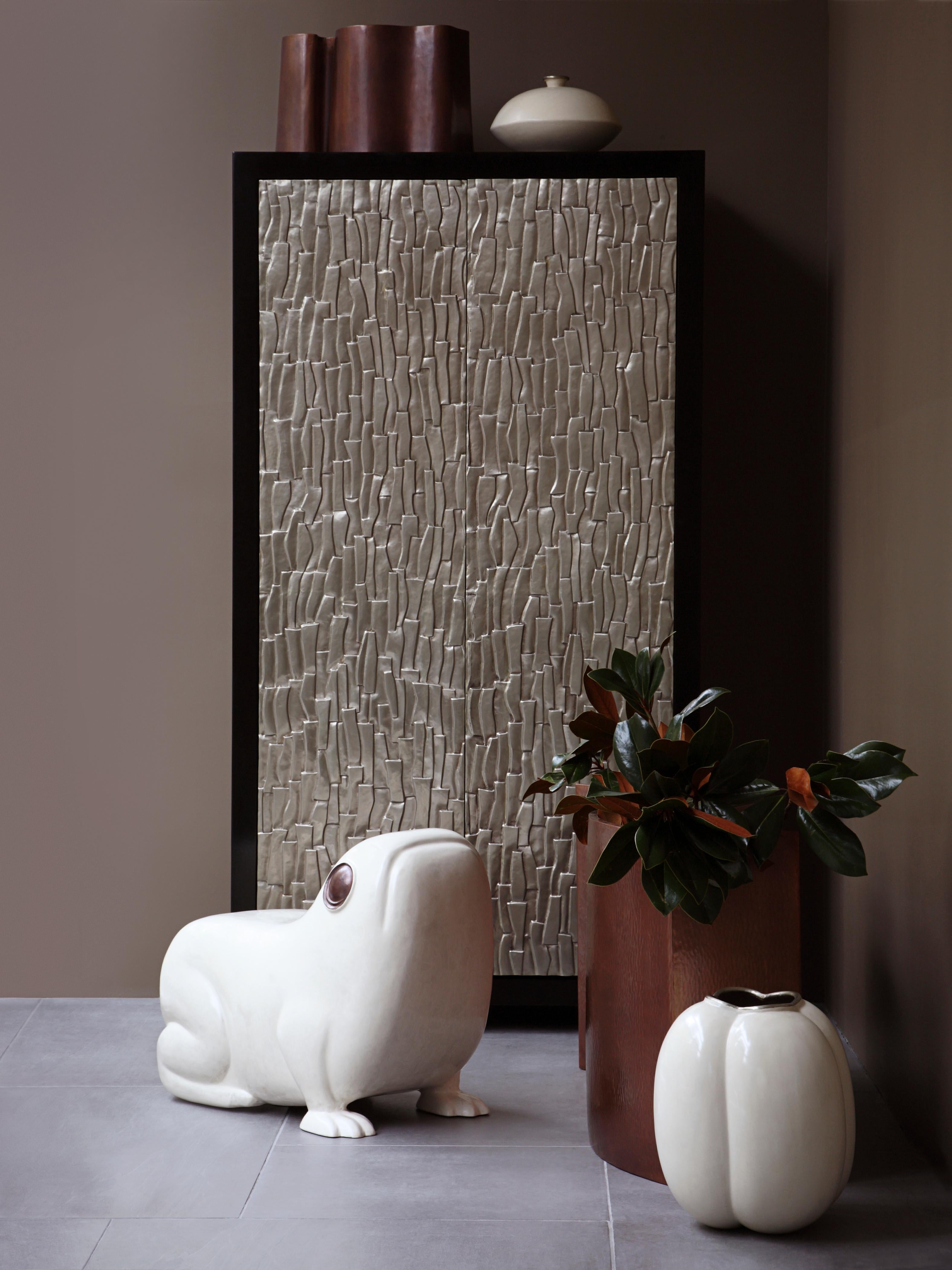Tall Kuai Cabinet
White Bronze Doors
Kuai Design
Hand Repoussé
Elm Wood
Contemporary
Limited Edition
Each piece is individually crafted and is unique. 


Repoussé is the traditional art of hand-hammering decorative relief onto sheet metal. The