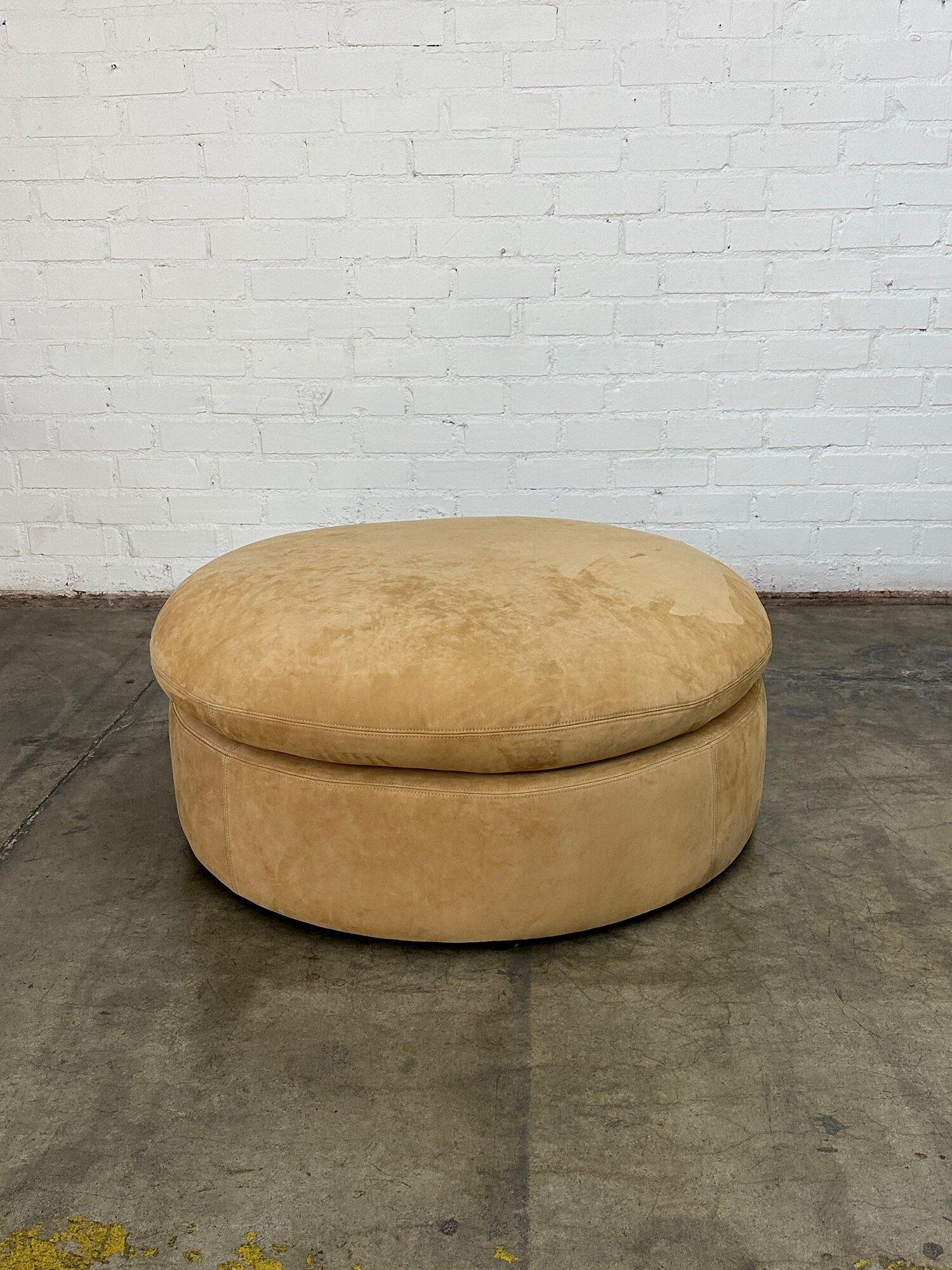W44 D44 H20

This ottoman is made with sanded leather with a soft buttery smooth texture in a tan or sand color. There pillow top is leather down and fixed to the base. Legs are low profile chocolate drop legs. 