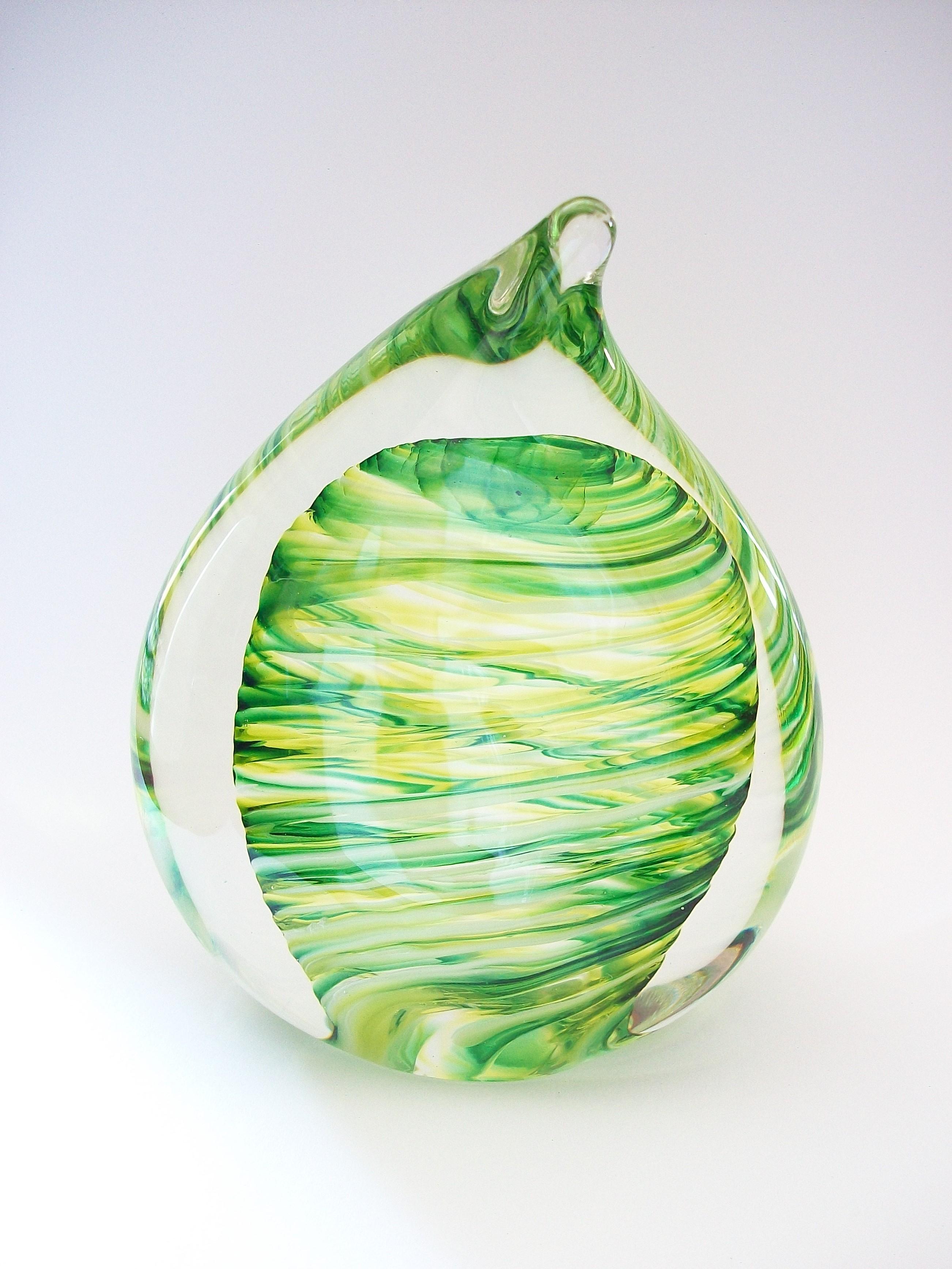 Contemporary studio glass 'teardrop' paperweight sculpture - hand made/mouth blown with striking green, white and yellow swirl center - indistinctly signed and dated on the base (unknown / unidentified maker) - Canada - circa 2012.

Excellent/mint