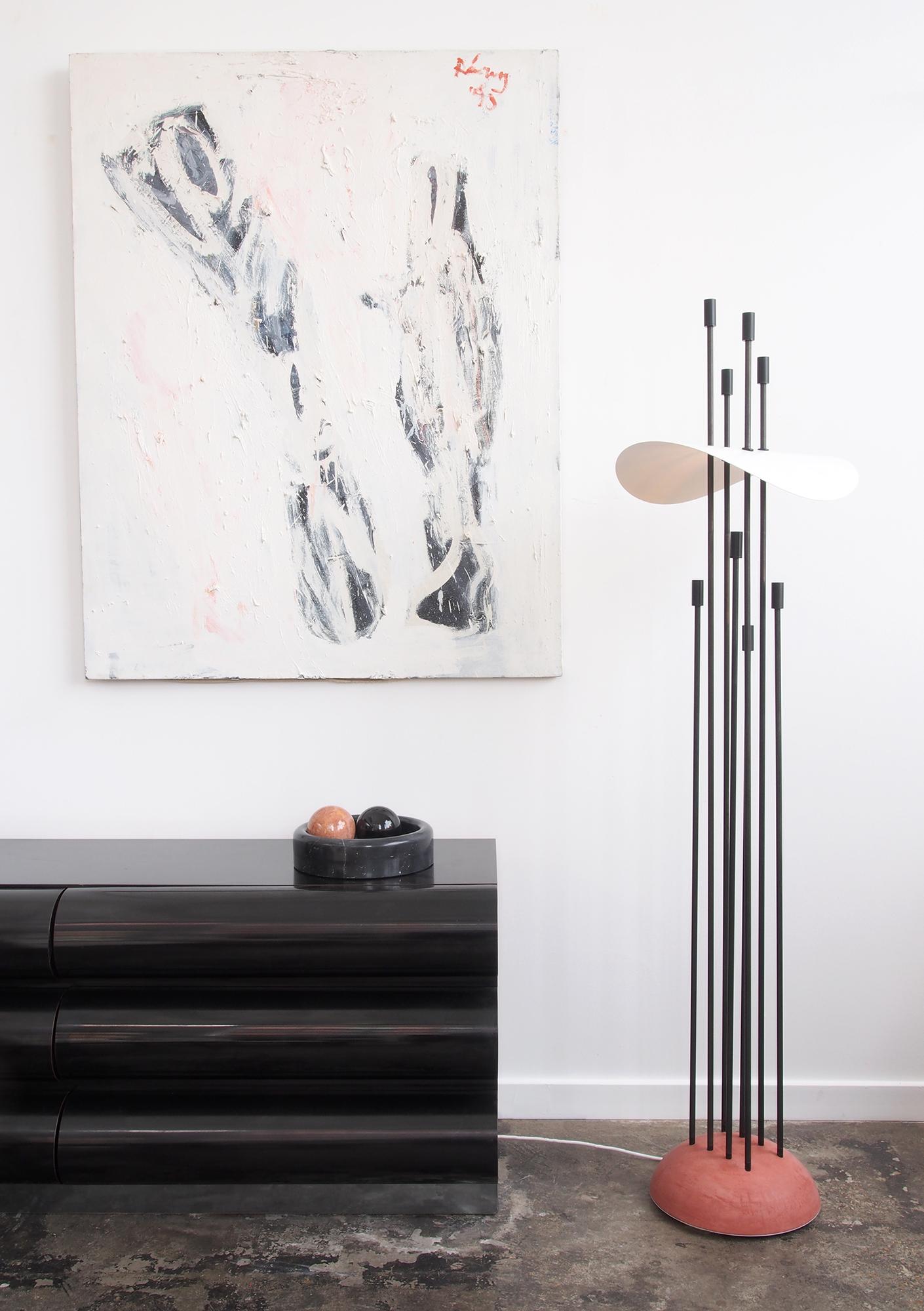Ida Floor Lamp’s vertical rods act as both light source and support for its curved white reflector. Four shorter rods direct light downward via the reflector, while four taller ones create an ambient glow on the ceiling and surrounding space.

UL