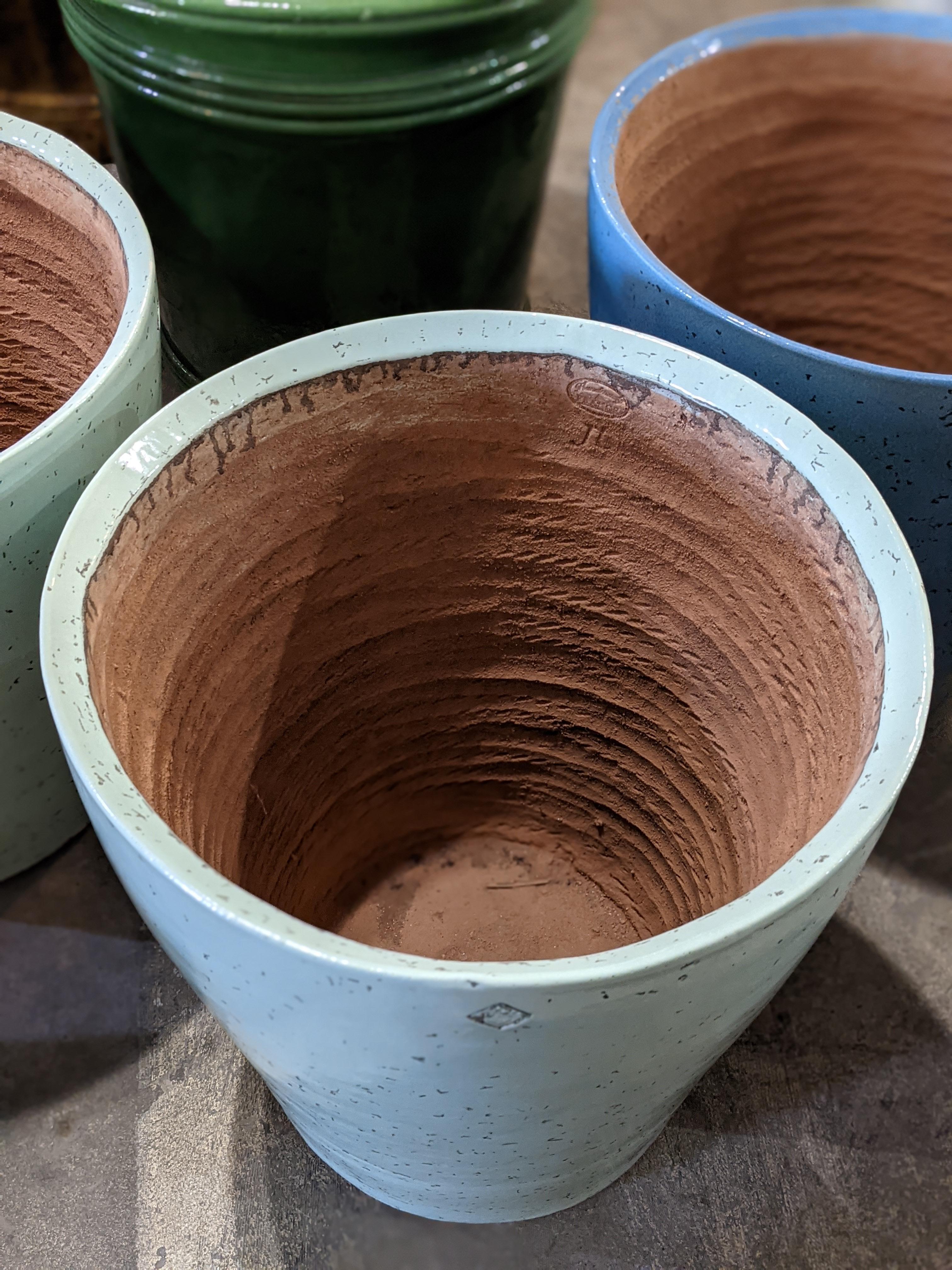 This terracotta planter origins from Bordeaux, in France.

Beautiful Opaline Green color.

It can also match with the blue one.

 