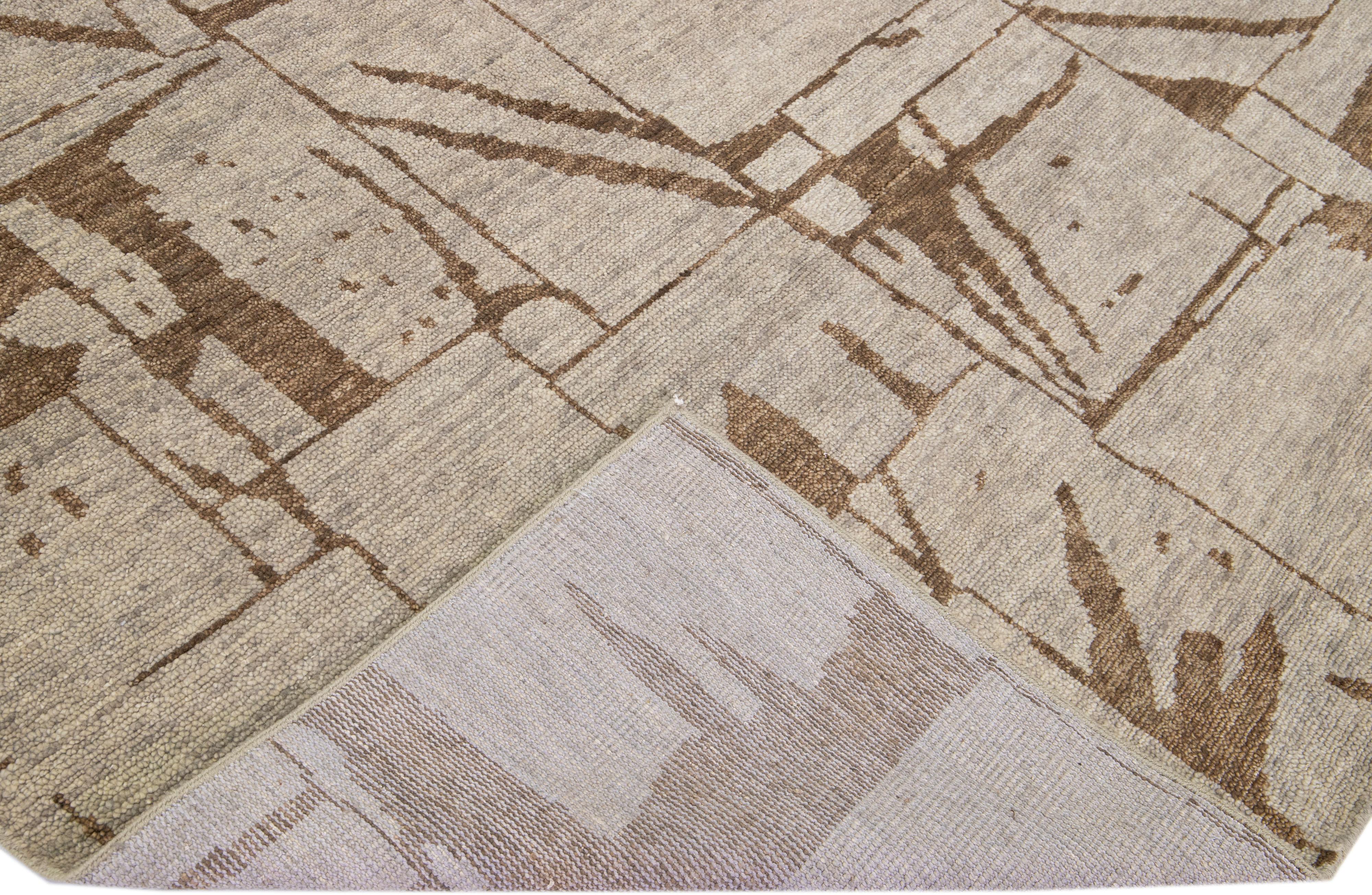 Beautiful Contemporary Thom Filicia Home Collection Rugs. This Indian hand-knotted rug is made of wool and has beige-tan field and brown accents all over the design. 
Thom Filicia´s eye for exquisite detailing and beautiful texture shines through