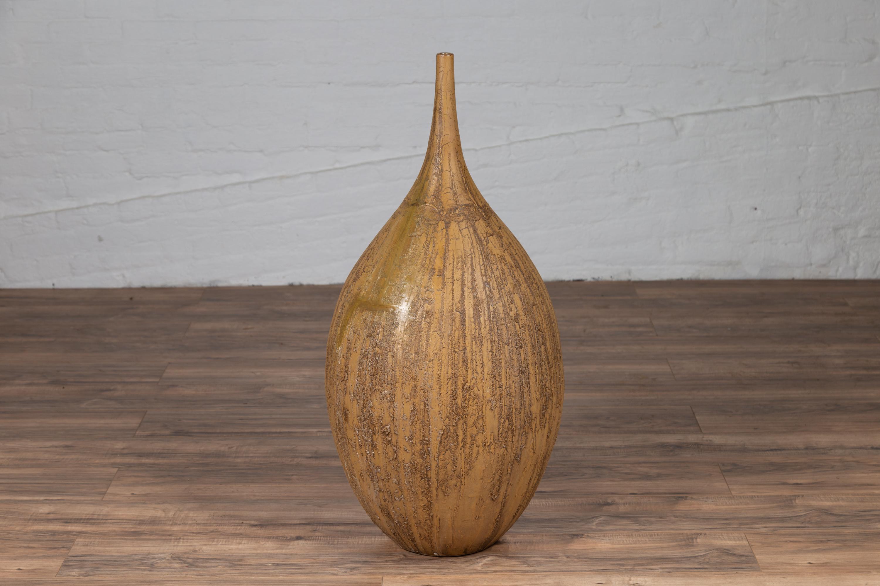 A contemporary Thai handmade ceramic vase with tapered spout and mustard glaze. Found in Chiang Mai, northern Thailand, this elegant contemporary handmade ceramic vase features a 'mustard' glaze beautifully enlivened by textured accents. Topped with