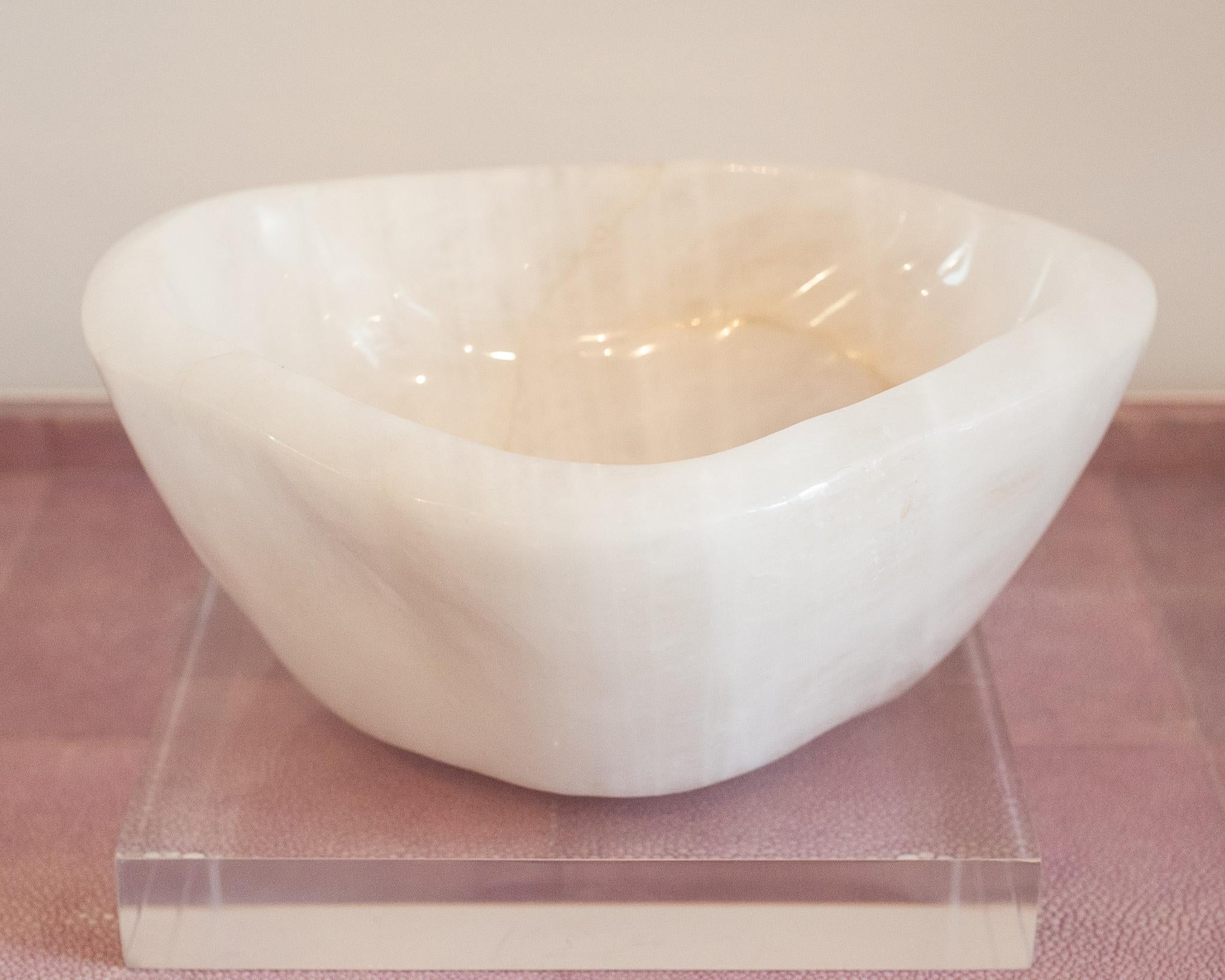 Bring the healing energy of rock crystal quartz into your home with this beautiful carved bowl. This substantial and thick cut bowl can filled with candies or kept sculptural as an empty vessel and placed in any space.