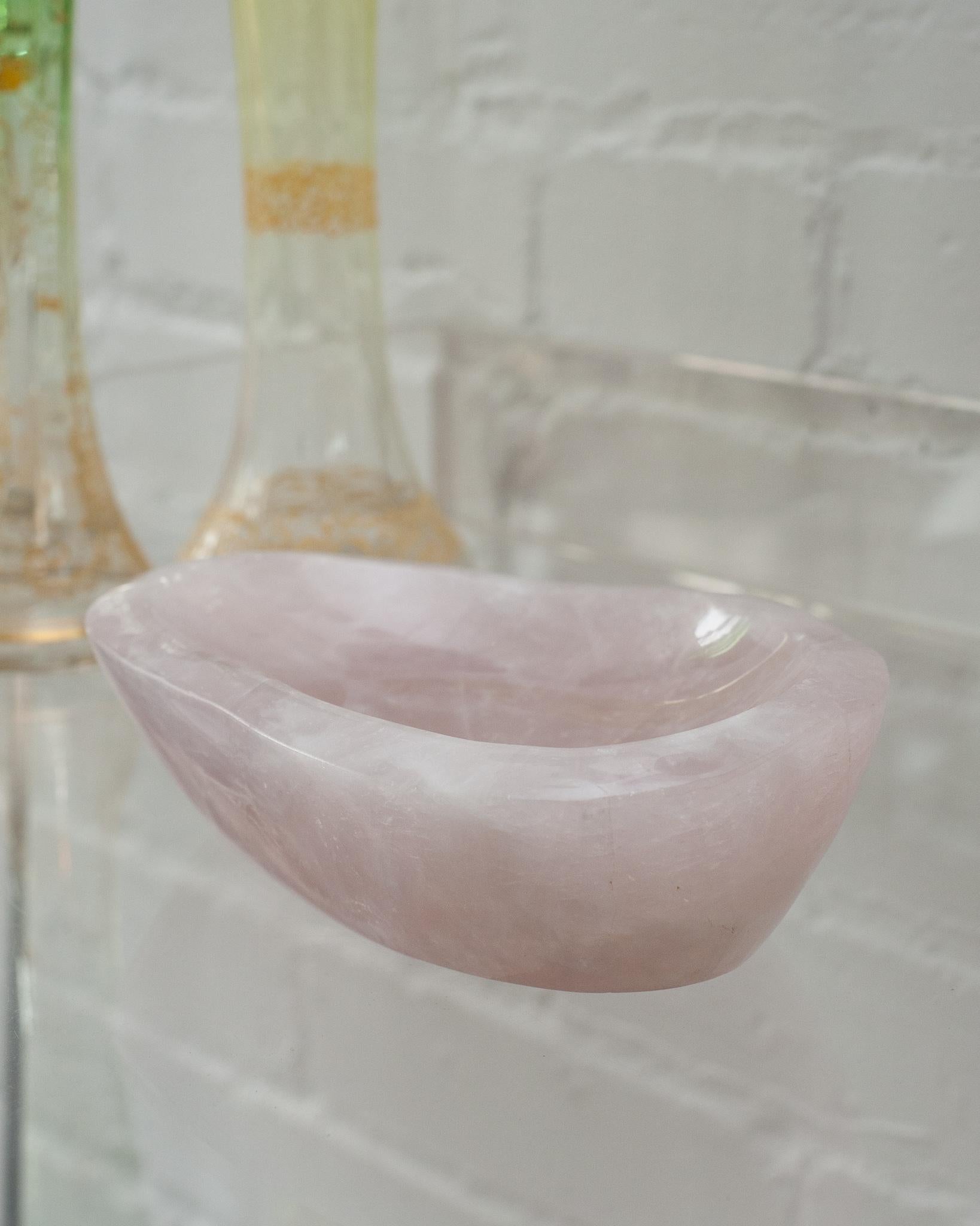 Bring the healing energy of rose quartz into your home with this beautiful carved bowl. This substantial and thick cut bowl can filled with candies or kept sculptural as an empty vessel and placed in any space. Rose quartz, the universal stone of