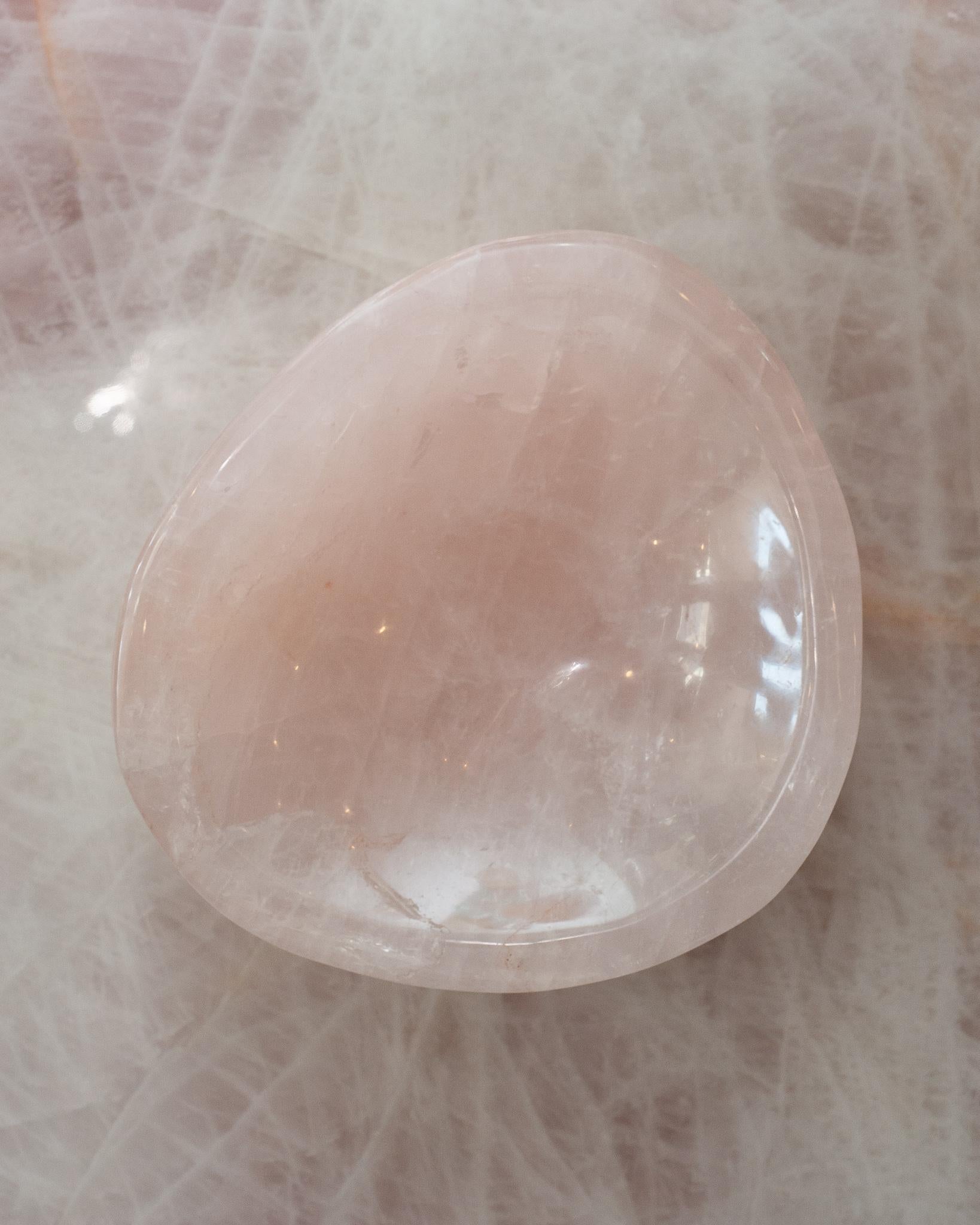 Bring the healing energy of rose quartz into your home with this beautiful carved bowl. This substantial and thick cut bowl can filled with candies or kept sculptural as an empty vessel and placed in any space. Rose quartz, the universal stone of