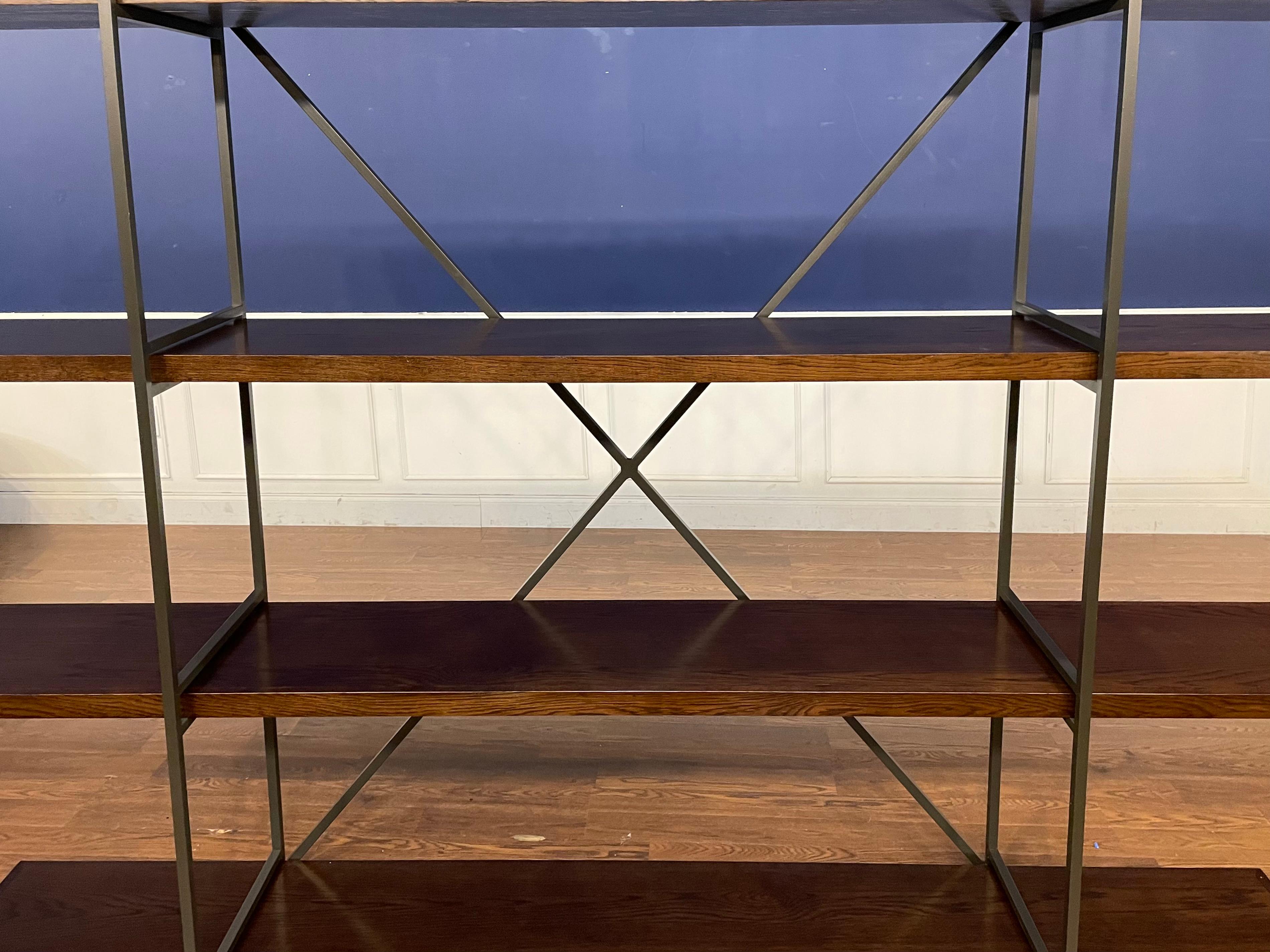 This is the Sullivan Bookcase from the exclusive Thomas O’Brien Collection of Century Furniture. It features an oil rubbed metal frame with removable brown/grayish oak shelves.  We estimate it to be 2-3 years old.  It is in good condition.  See