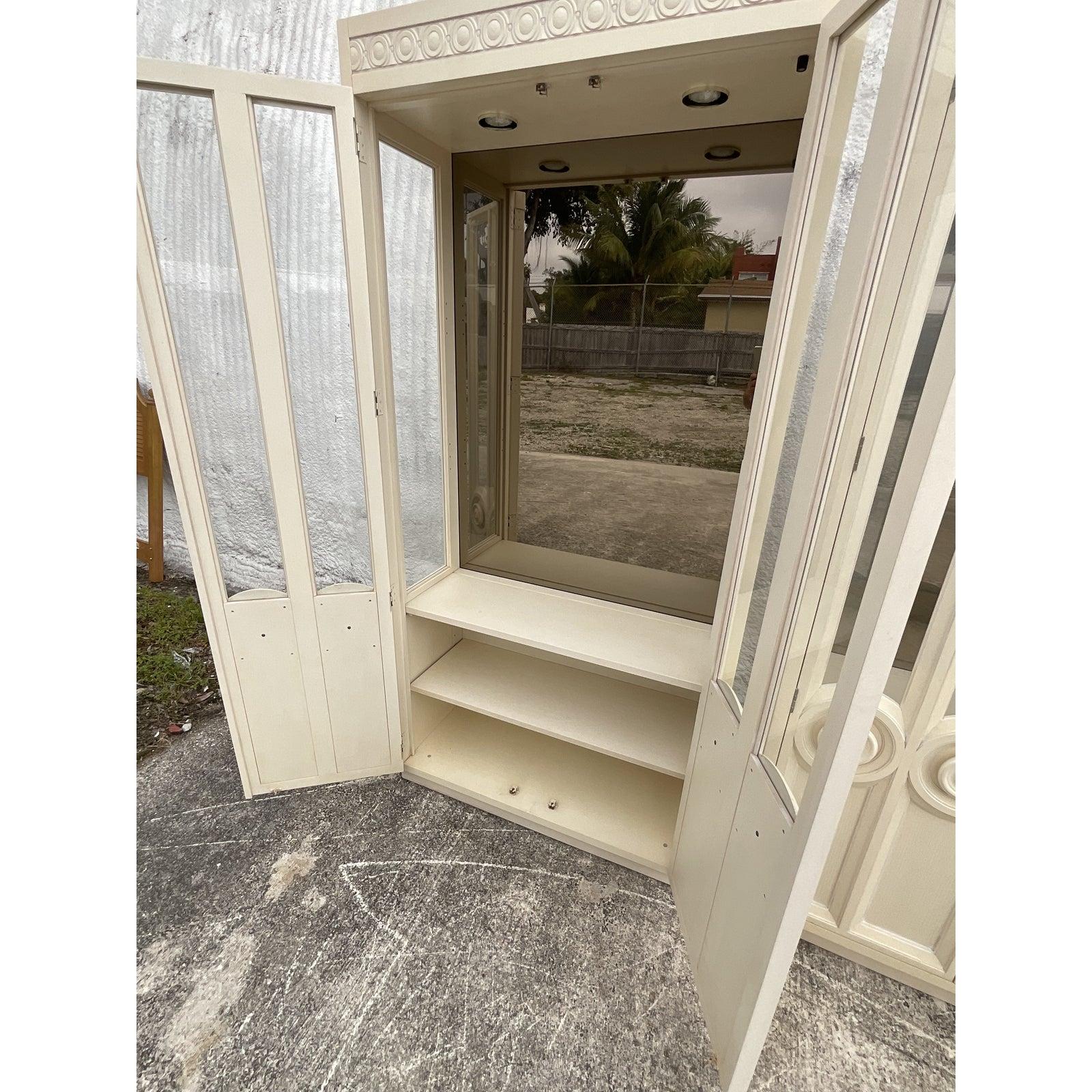 The most amazing pair of vintage Thomasville Etagere. Beautiful tall cabinet with the chicest carved circle handles. They are so impressive when nest to each other. Smoked mirror with three glass shelves in each. Lots of additional storage below.