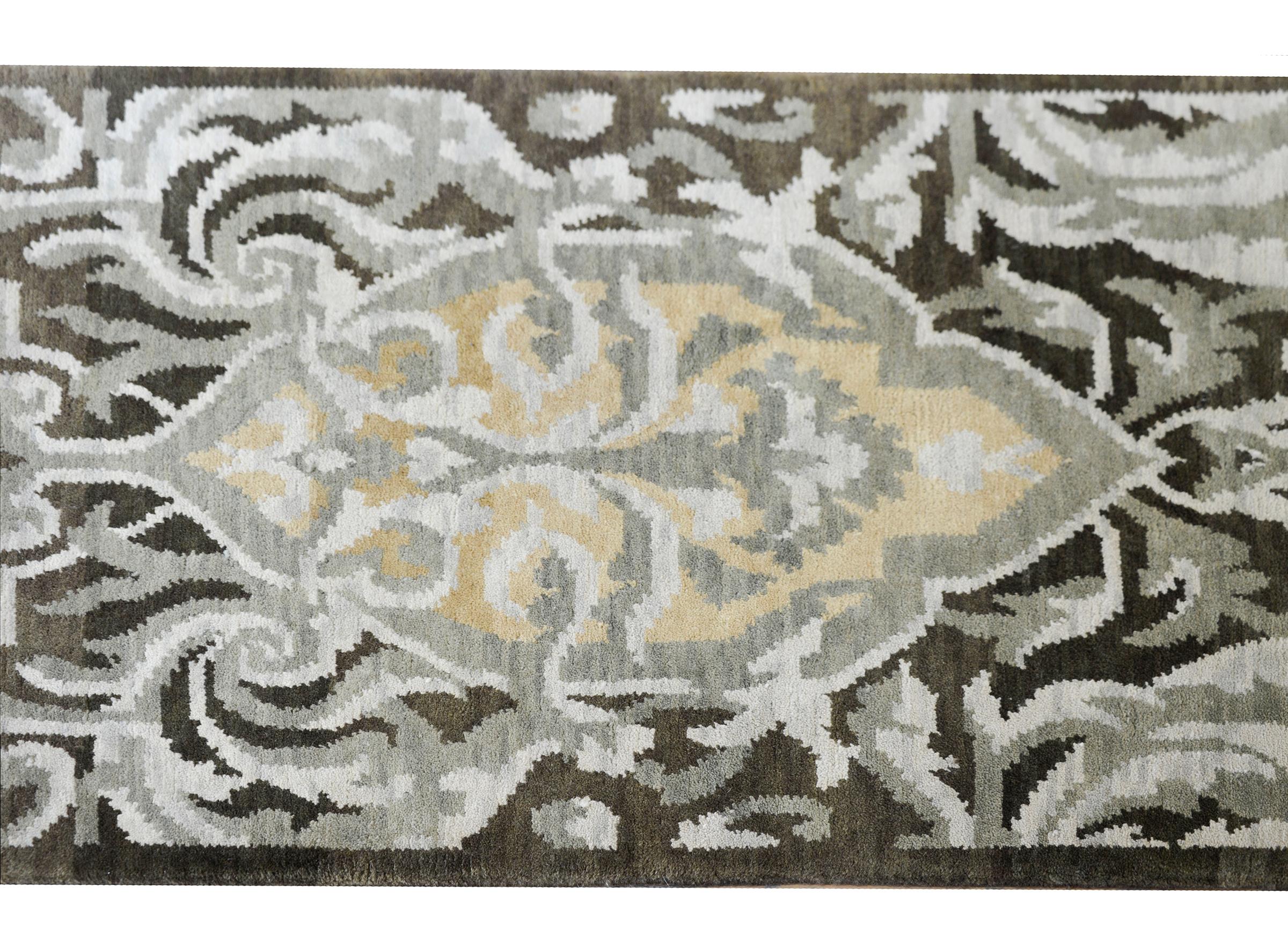 A contemporary Tibetan hand-knotted wool rug with a baroque-inspired floral pattern with acanthus leaves and flowers woven in varying shades of gray and gold, and set against a dark gray background.