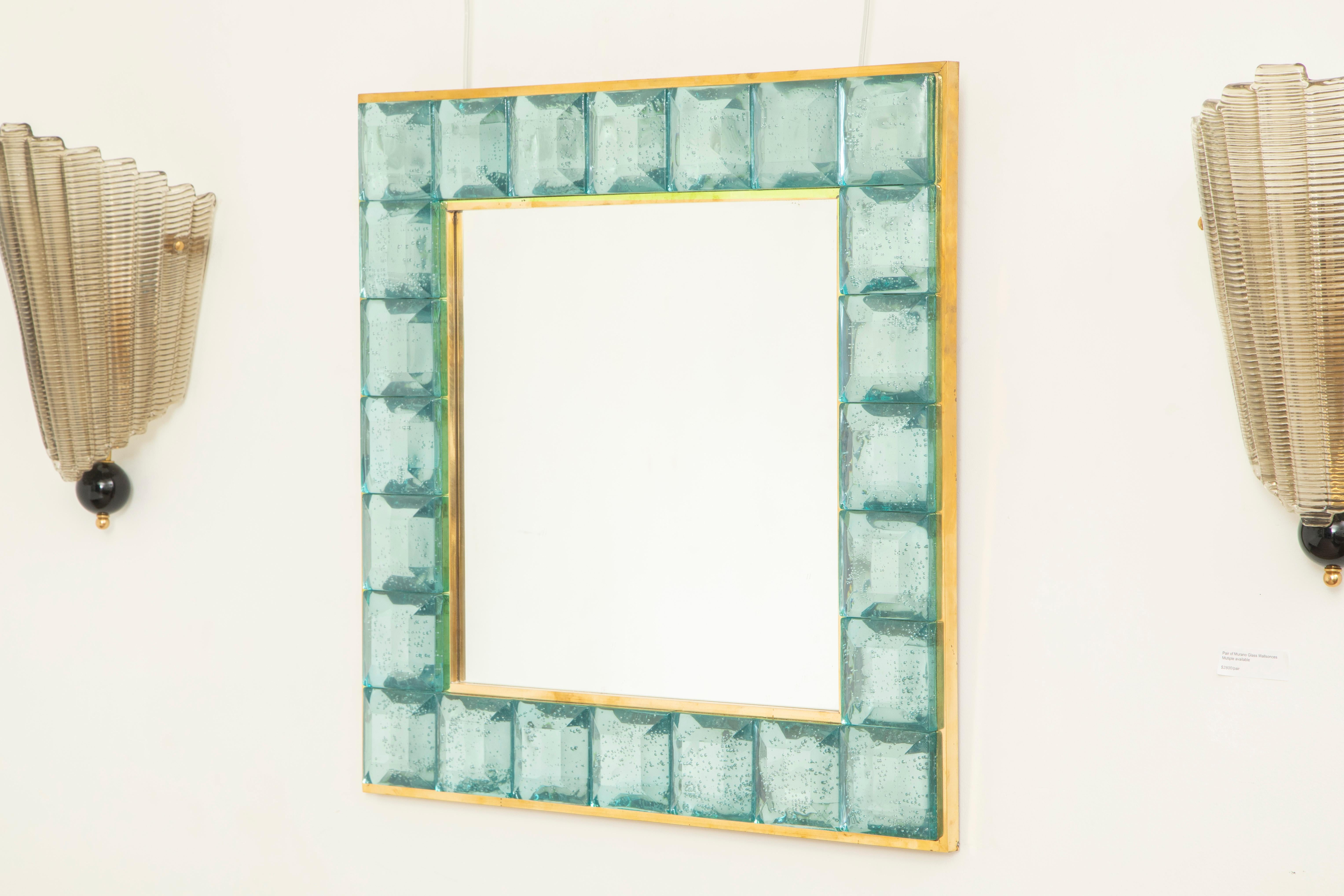 Contemporary Tiffany blue square diamond cut Murano glass mirror.
 Glass block with naturally occurring air inclusions throughout 
 Highly polished faceted pattern
 Brass gallery
 Luxury handcrafted by a team of artisans in Venice, Italy.
 Weight