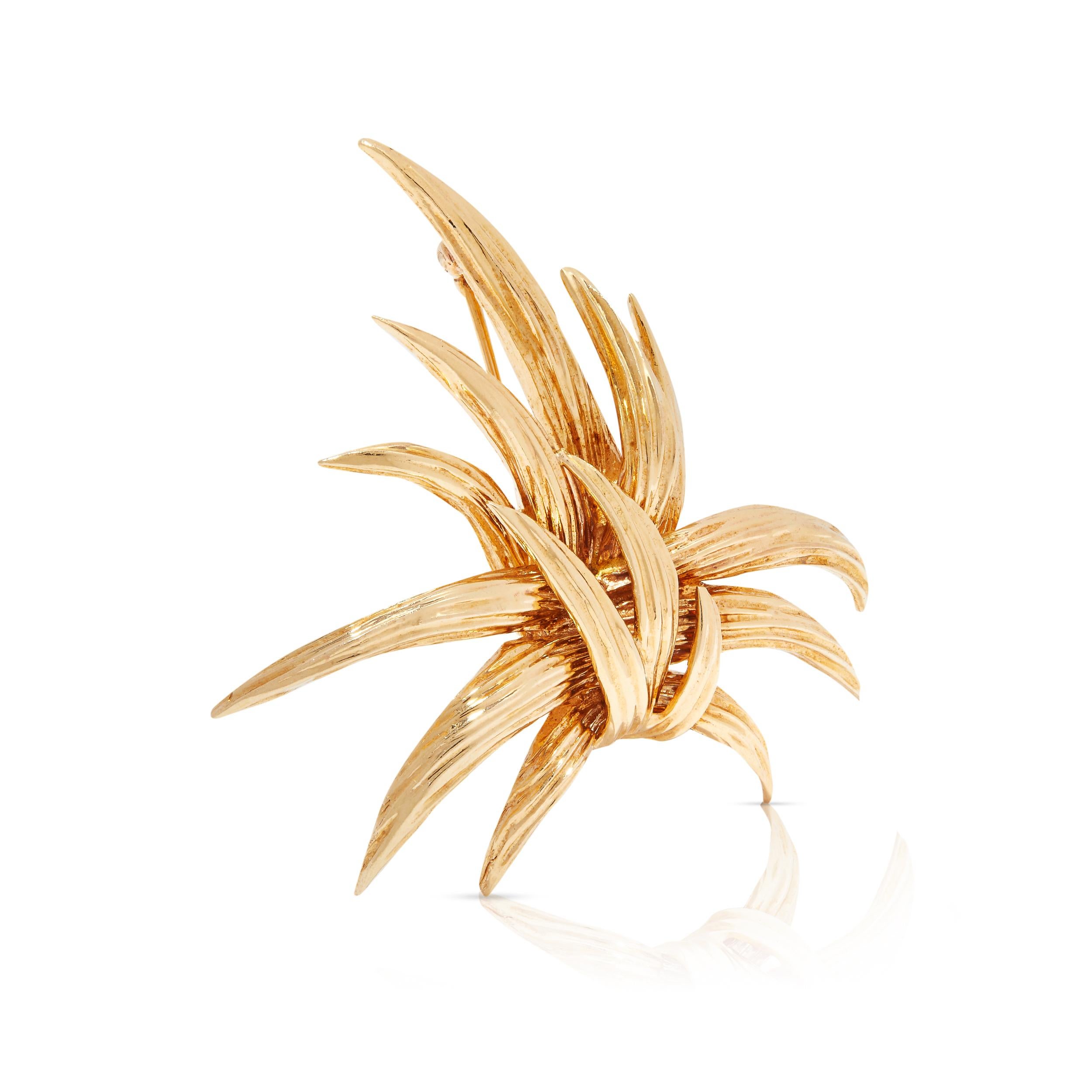 This spectacular gold brooch is designed to turn heads and distract eyes during conversations. The kinetic spray motif is composed of shiny 14ct gold spikes, curved outward and sleekly finished in stroke and flute detailing. Gorgeous and impressive,
