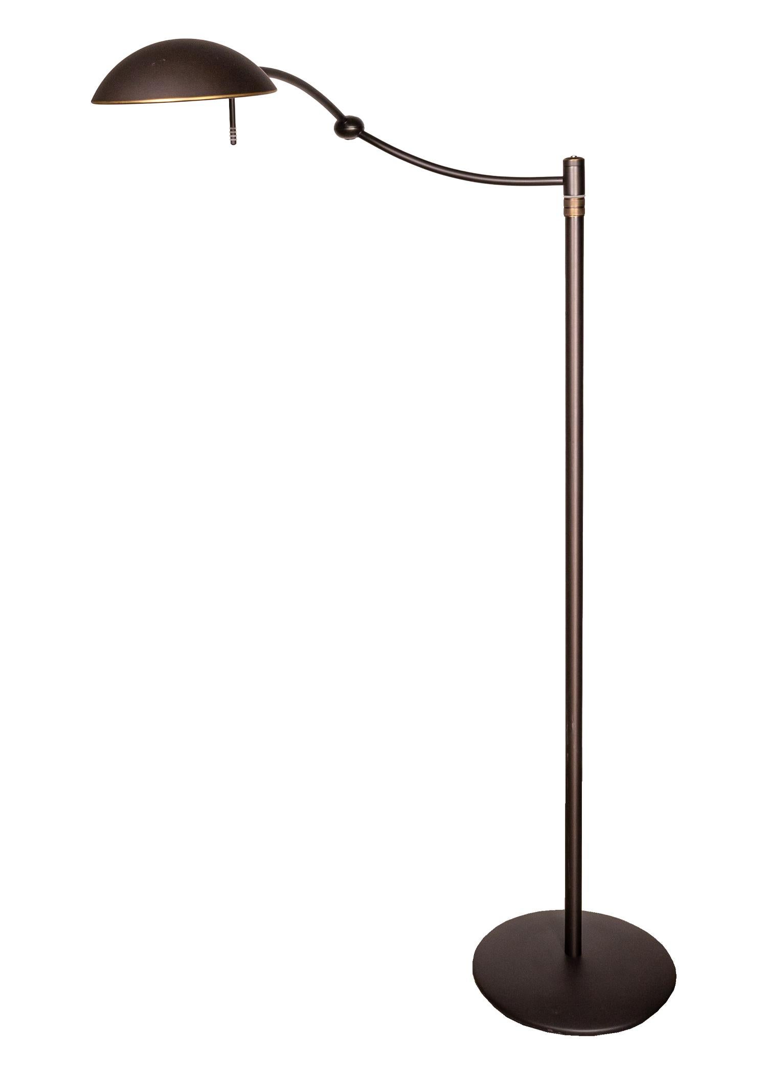 A pair of Holtkotter swing arm metal floor lamps. A fantastic pair of floor lamps featuring a very elegant fade-in, fade-out light. The bulb fades in as you switch it on. When turning off, the lamp turns partially off and holds for approximately ten