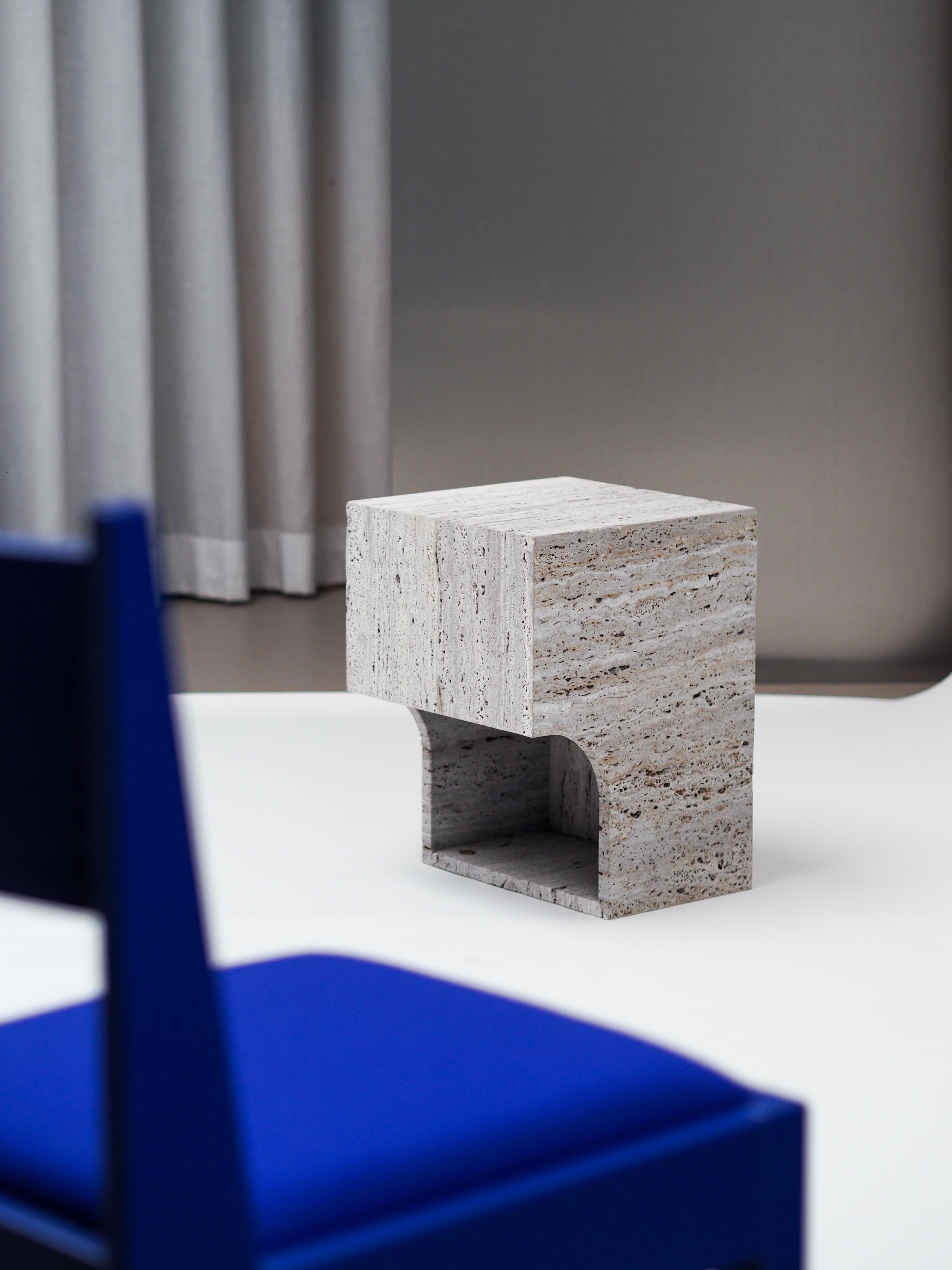 arch 01.2 c is a stool or side table. The arch 01.2 c takes things a little bit further than its precedent, the arch 01.1 c. It was designed into our latest travertine collection. A beautiful object that can fill a room on its own. The unveiled