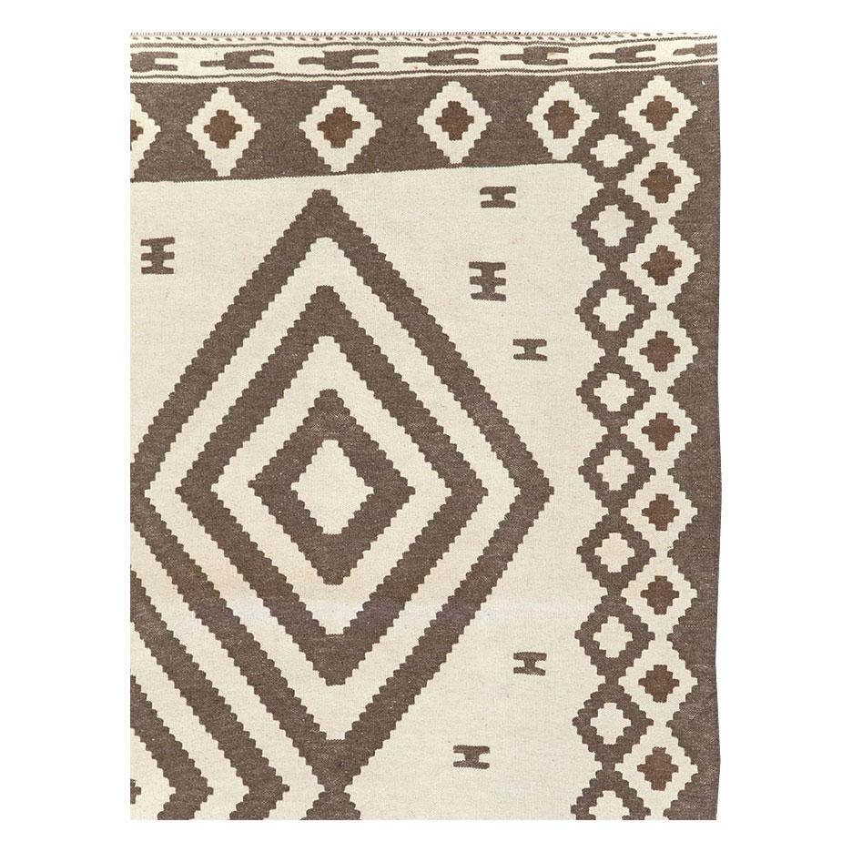 A modern Persian flatwoven Kilim small room size carpet, in gallery format, handmade during the 21st century in the tribal style.

Measures: 6' 7