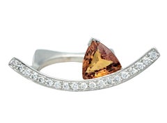 Contemporary Trillion Cut Spessitite and Pave Diamond Ring in 18 Karat Gold