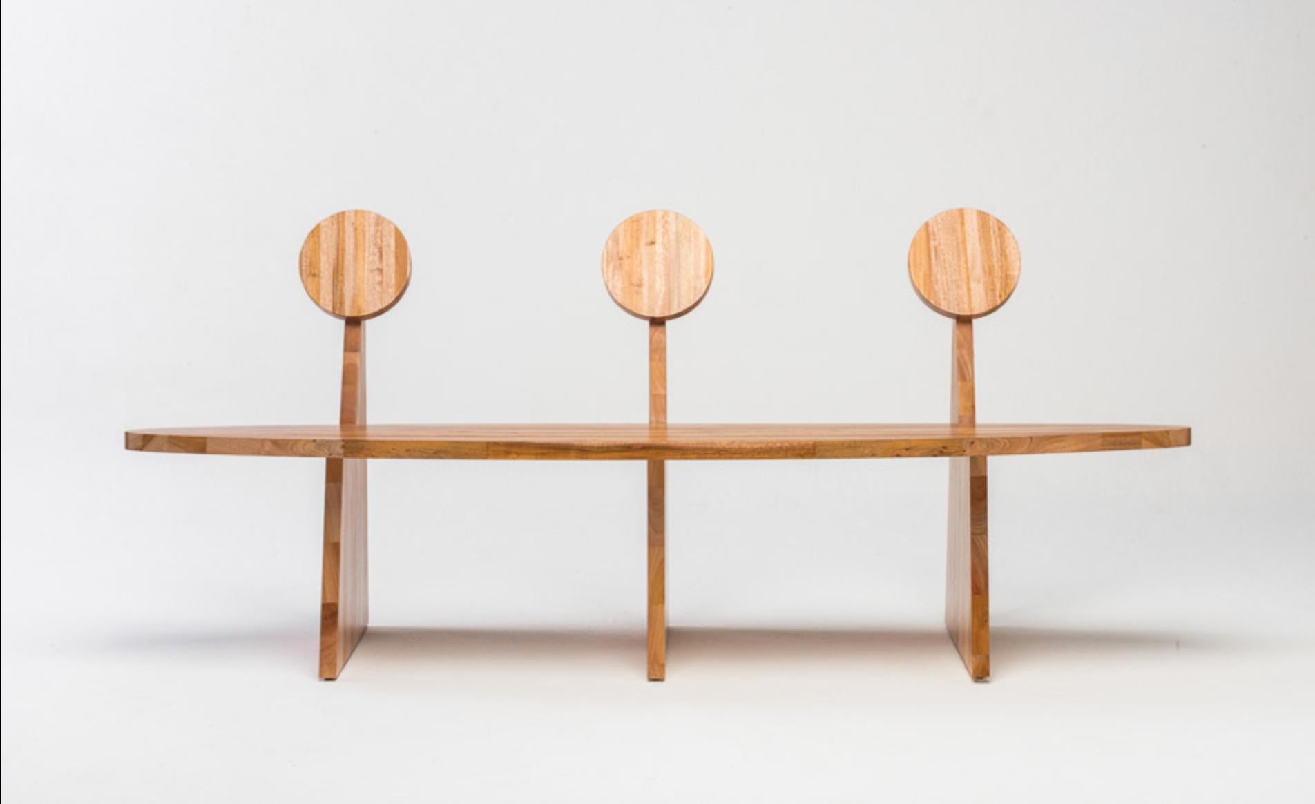 Designed by Juliana Lima Vasconcellos in 2018, the trio bench in made in solid African mahogany wood panels. This bench has a contemporary and simple image, inspired by pure geometric shapes and furniture of pre-modernist architects. The