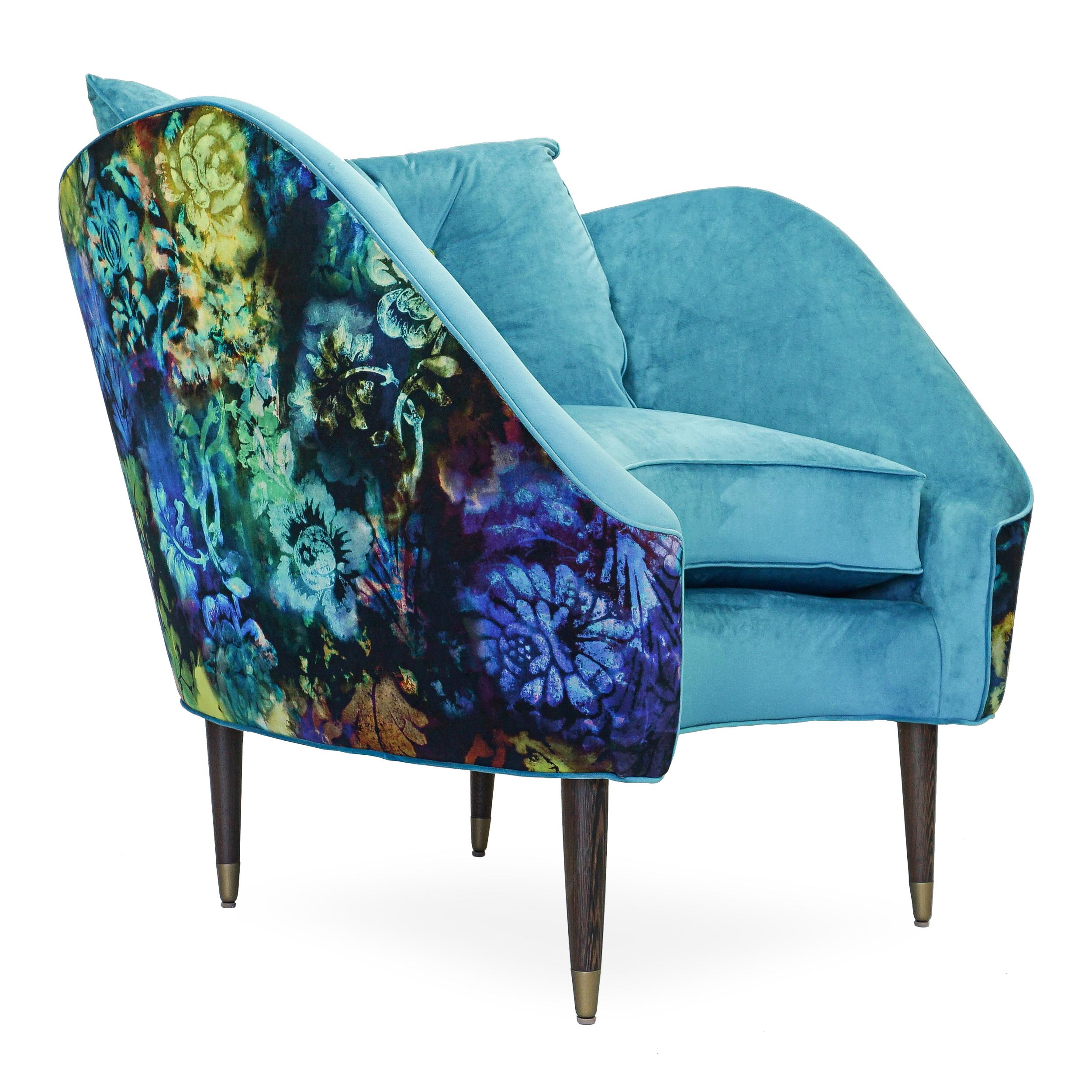 Designed by Jhon Ortiz and built in CT USA this chair is most defined by its curved profile. Shown with a turquoise velvet and with a psychedelic floral printed velvet on the outside back. Features brass sabots and a tufted back cushion. The chair