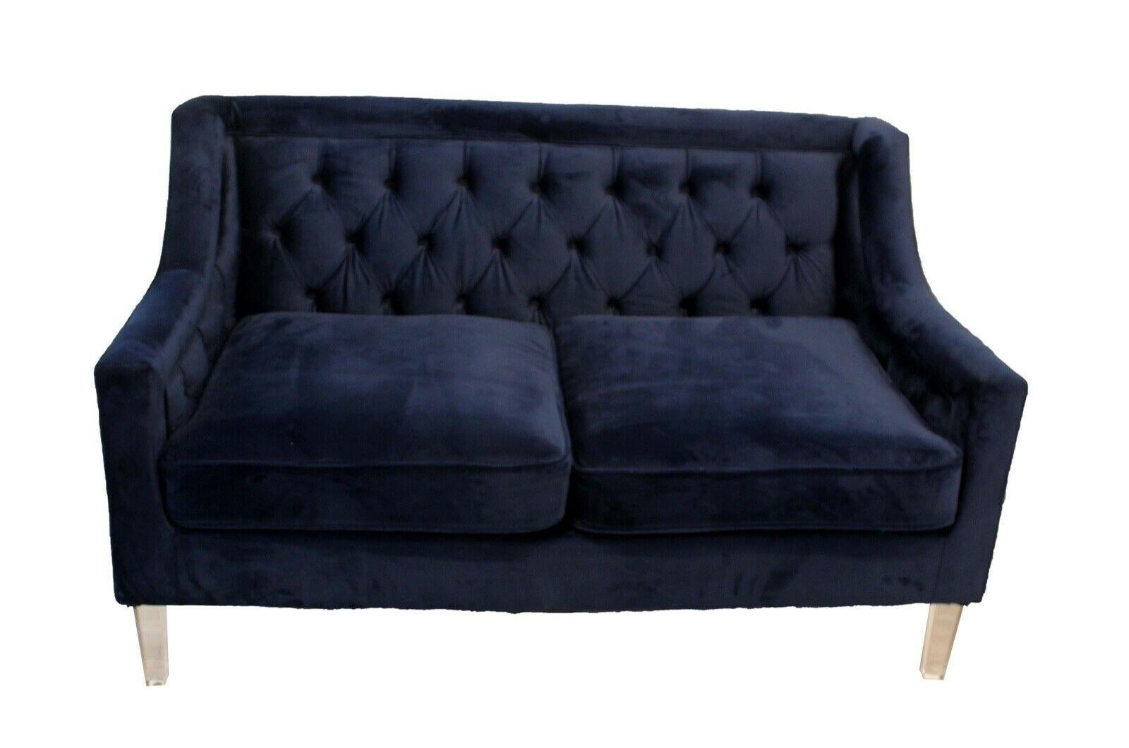In a stunning cobalt blue velvet, this sofa and loveseat gives a nod to both traditional and modern making this the ideal transitional piece. Both the chair and sofa are detailed with modern lucite legs as well as classic tufted buttons on the back.