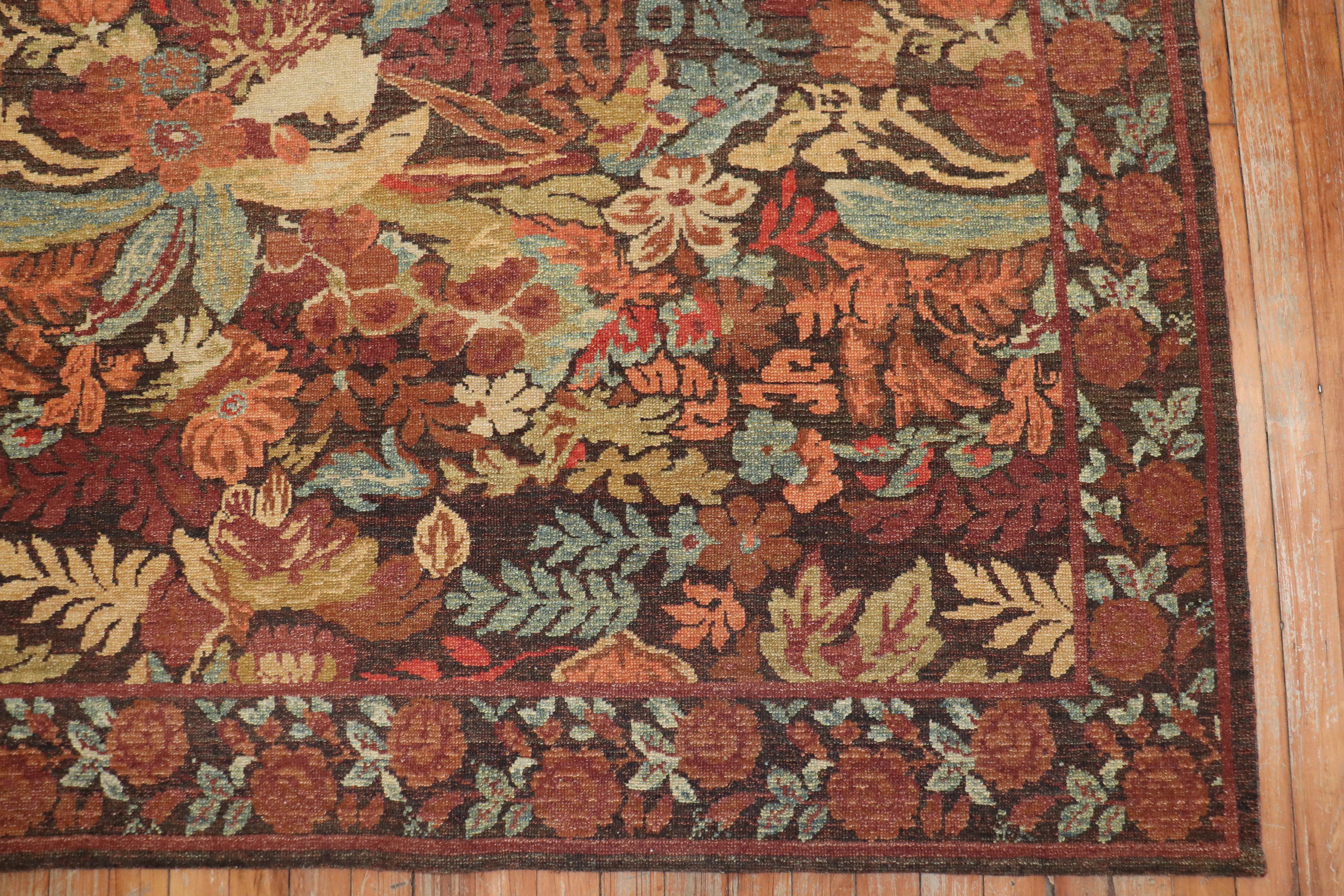 21st century Turkish contemporary wool rug with a an all-over floral design in field and border with autumn colors.

Measures: 8' x 10'.