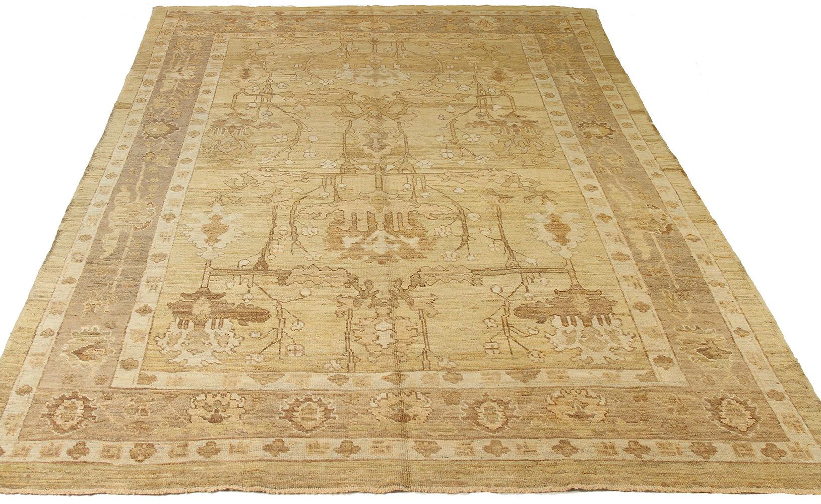 Contemporary handmade Turkish area rug from high-quality sheep’s wool and colored with eco-friendly vegetable dyes that are proven safe for humans and pets alike. It’s a Donegal design showcasing an ivory field with beautiful white and brown floral