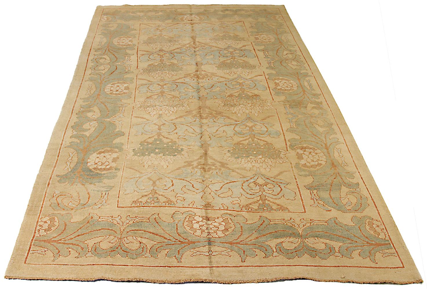 Contemporary handmade Turkish area rug from high-quality sheep’s wool and colored with eco-friendly vegetable dyes that are proven safe for humans and pets alike. It’s a Donegal design showcasing a beige field with beautiful gray and green floral