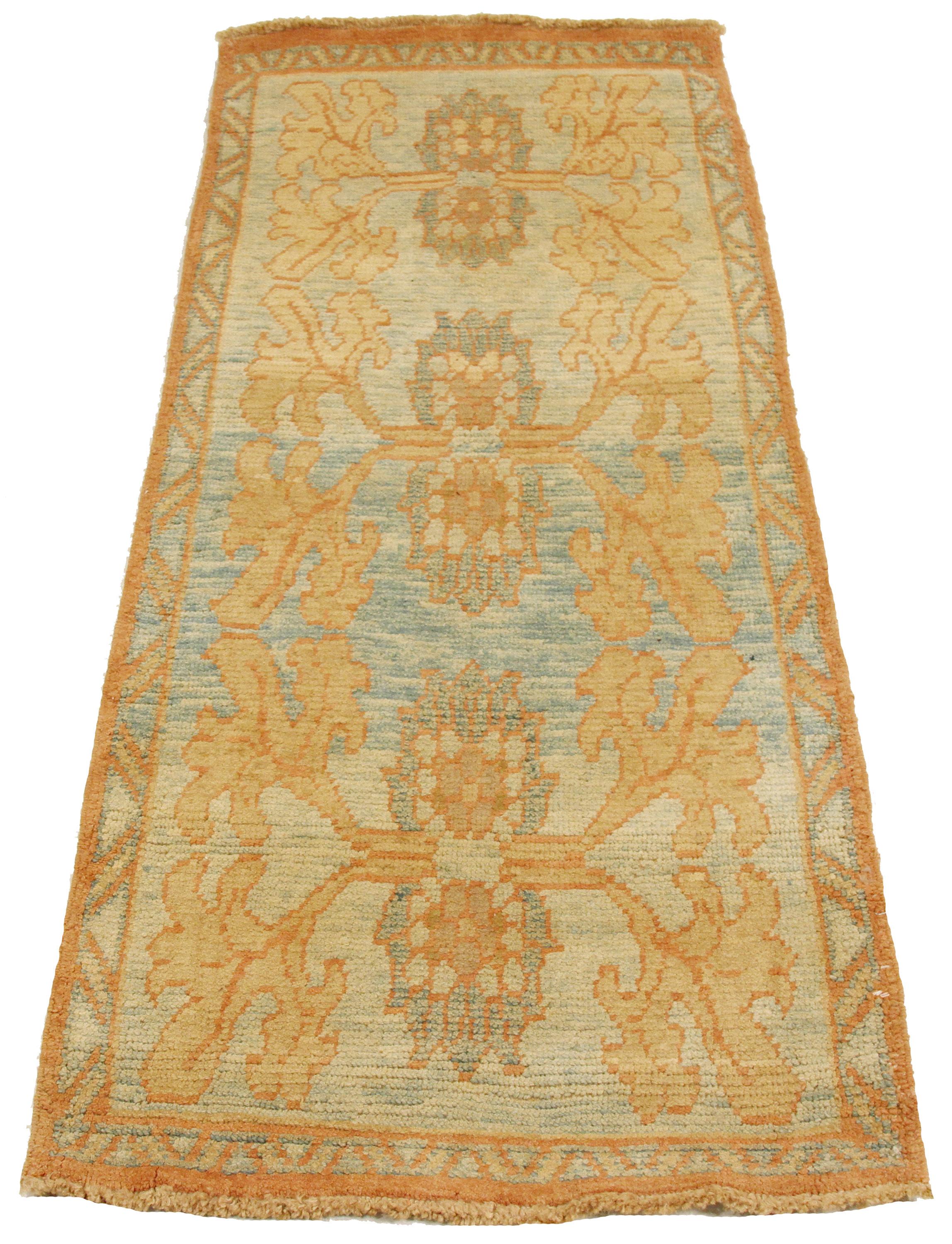 Contemporary handmade Turkish rug from high-quality sheep’s wool and colored with eco-friendly vegetable dyes that are proven safe for humans and pets alike. It’s a Donegal design showcasing a blue field with beautiful ivory and brown botanical