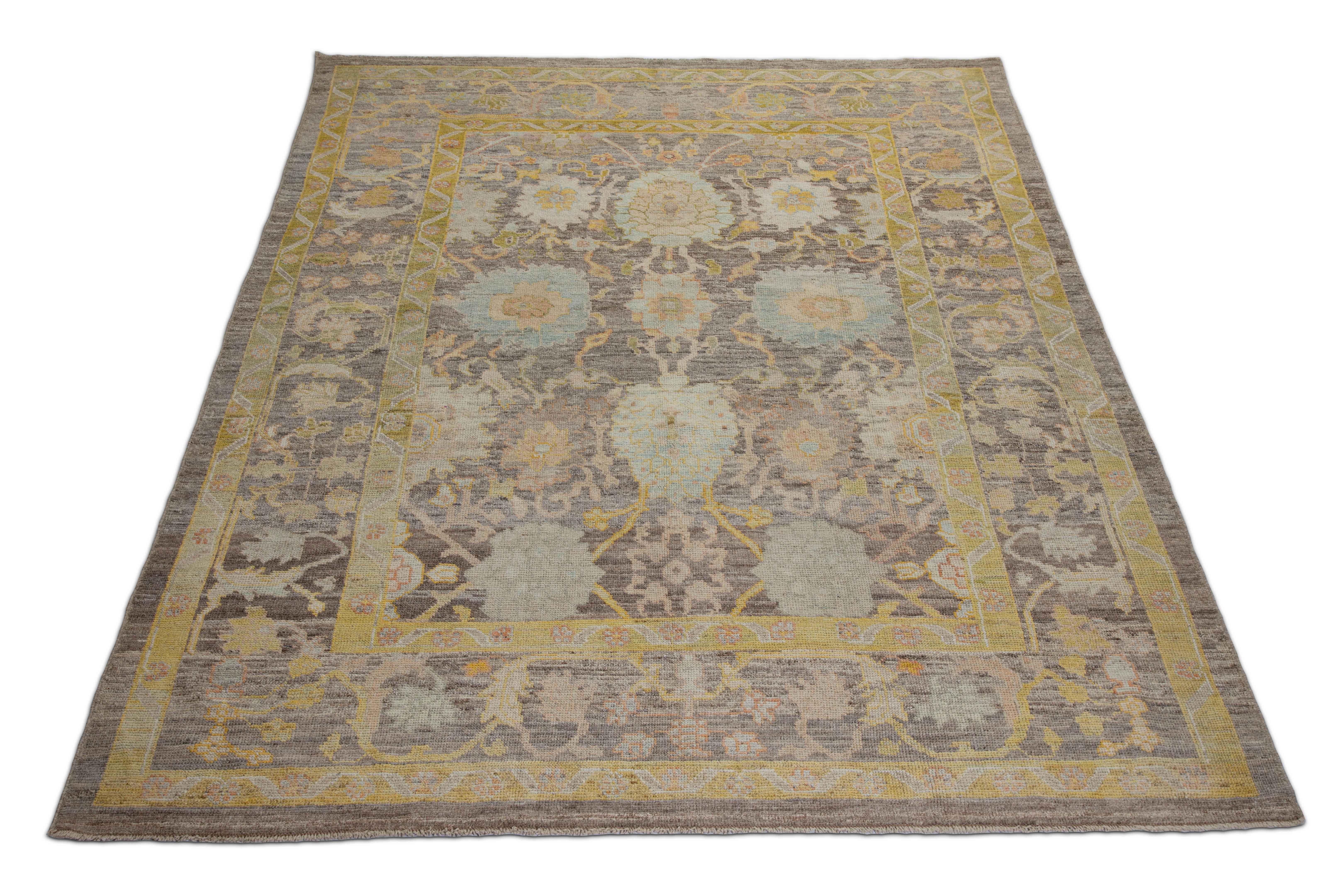 New Turkish rug made of handwoven sheep’s wool of the finest quality. It’s colored with organic vegetable dyes that are certified safe for humans and pets alike. It features a large, brown field with flower details allover associated with Oushak