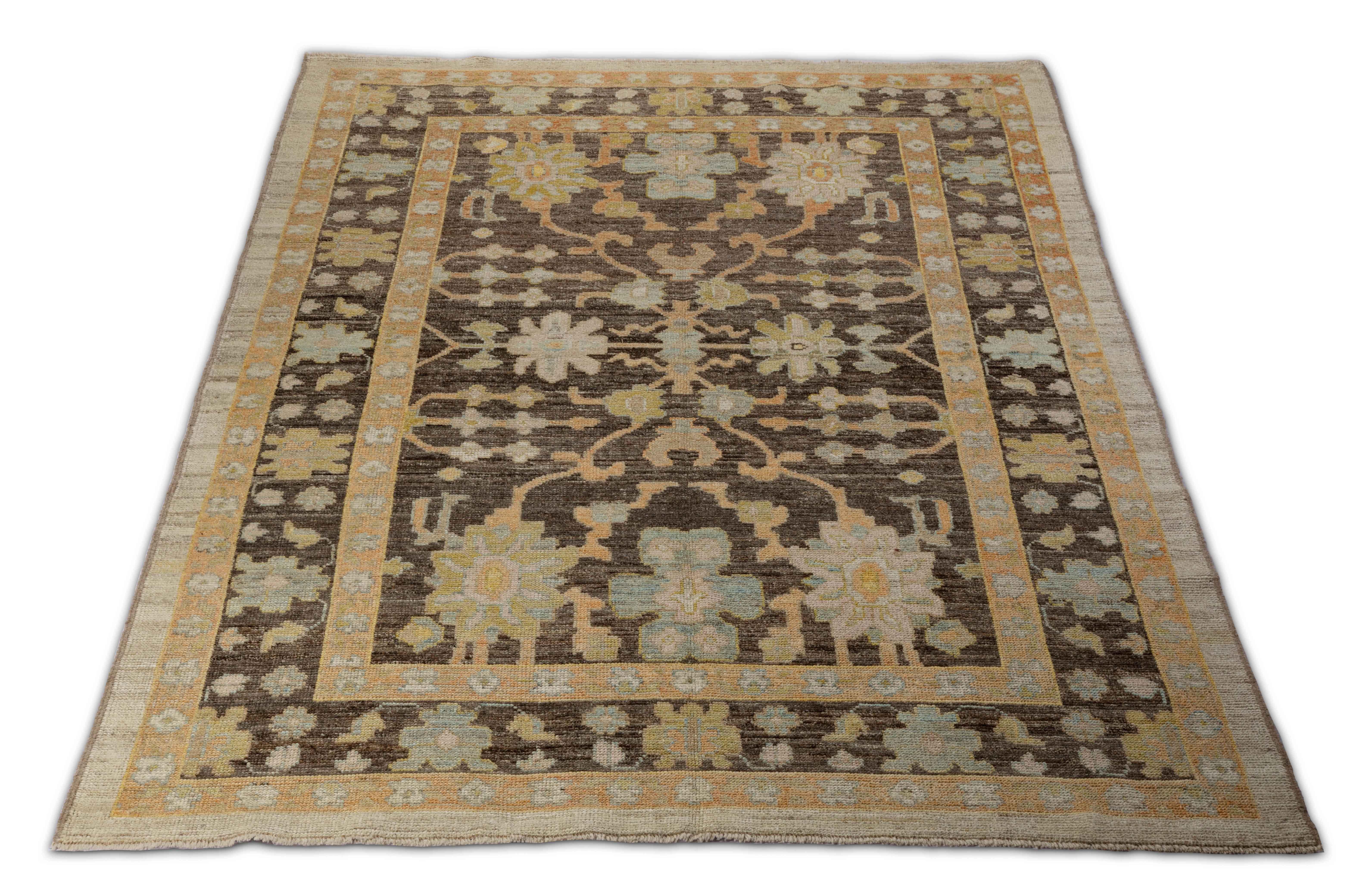 Contemporary Turkish rug made of handwoven sheep’s wool of the finest quality. It’s colored with organic vegetable dyes that are certified safe for humans and pets alike. It features a brown field with flower head details allover associated with