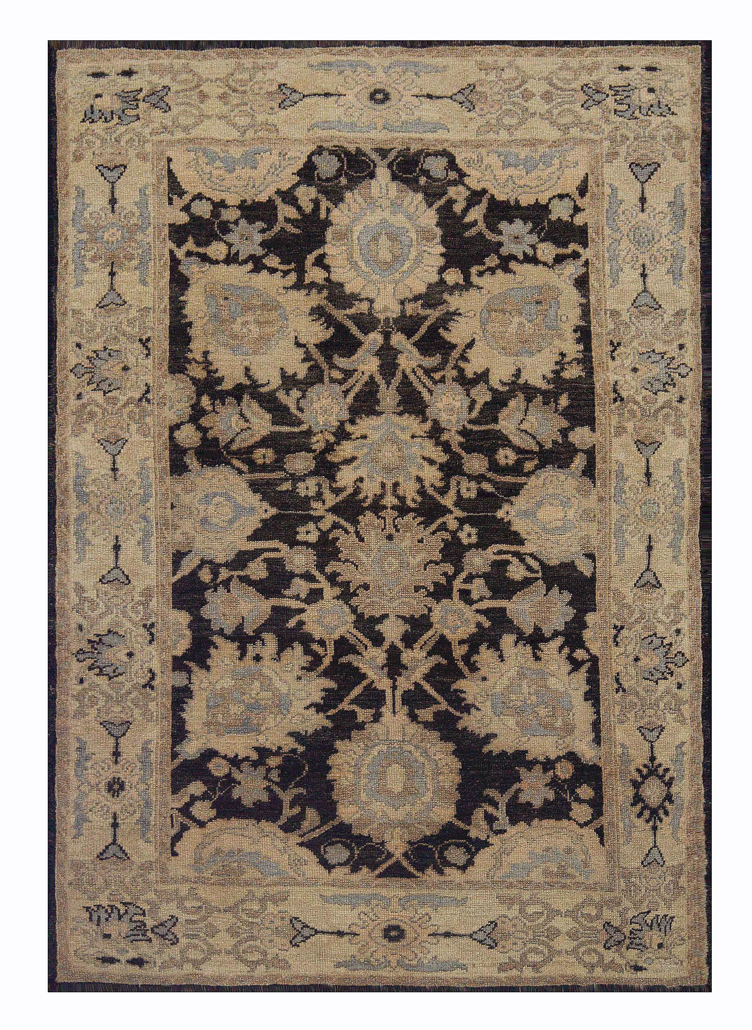 Contemporary Turkish rug made of handwoven sheep’s wool of the finest quality. It’s colored with organic vegetable dyes that are certified safe for humans and pets alike. It features a black center field with flower details in gray and beige