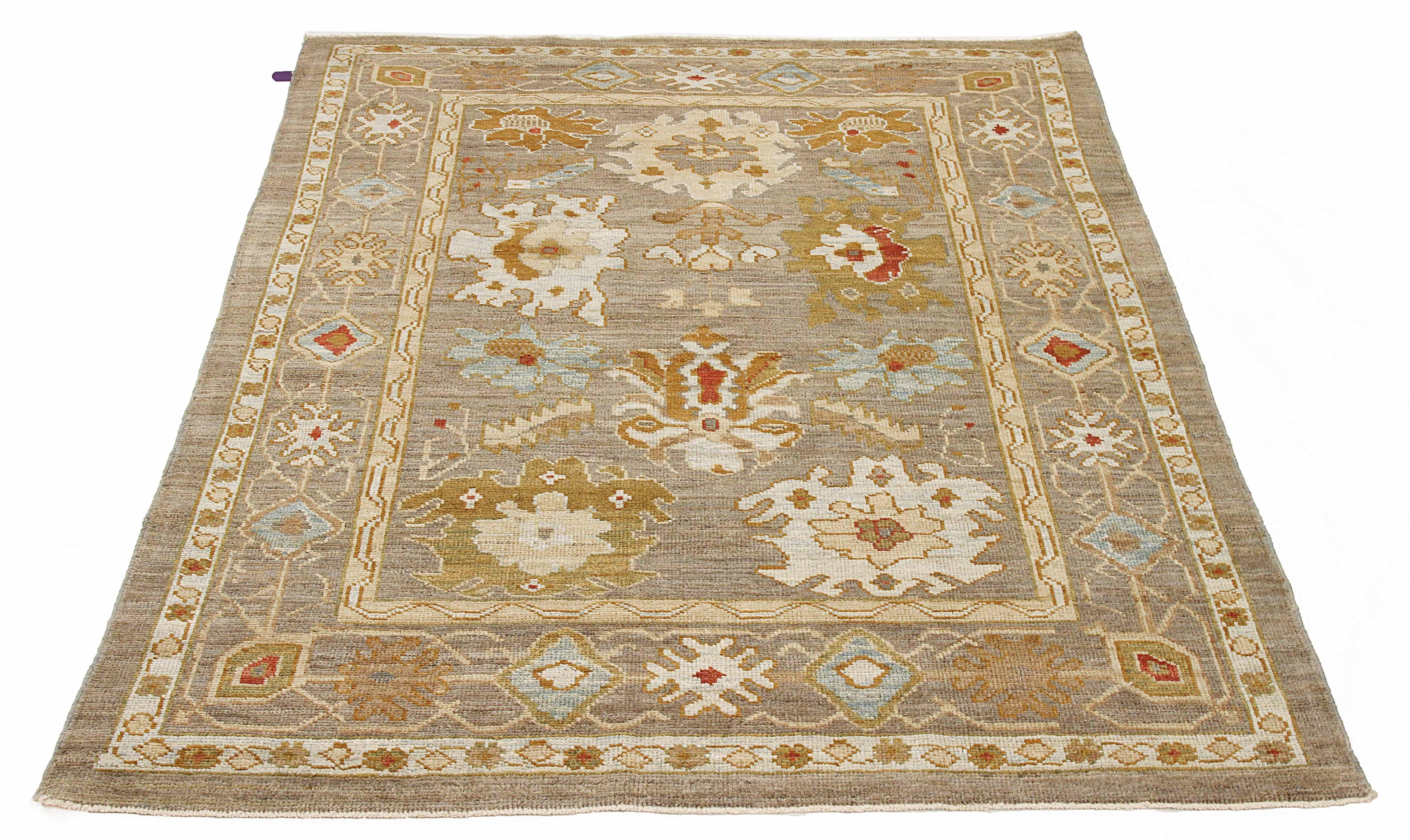 Contemporary Persian rug made of handwoven sheep’s wool of the finest quality. It’s colored with organic vegetable dyes that are certified safe for humans and pets alike. It features rows of flower medallion details allover associated with Oushak