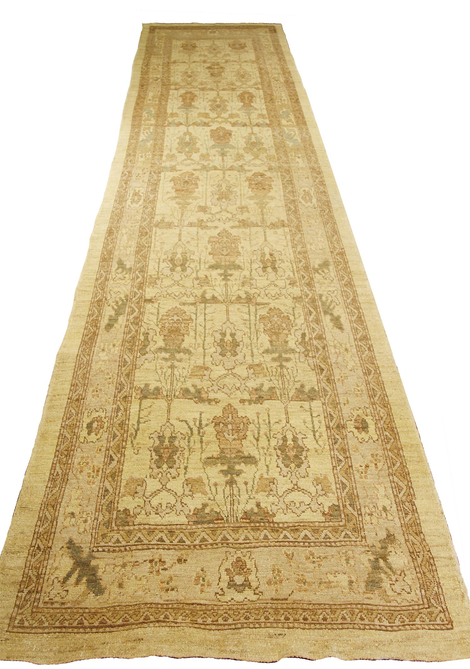 Contemporary Turkish runner rug made of handwoven sheep’s wool of the finest quality. It’s colored with organic vegetable dyes that are certified safe for humans and pets alike. It features rows of flower details all-over associated with Oushak