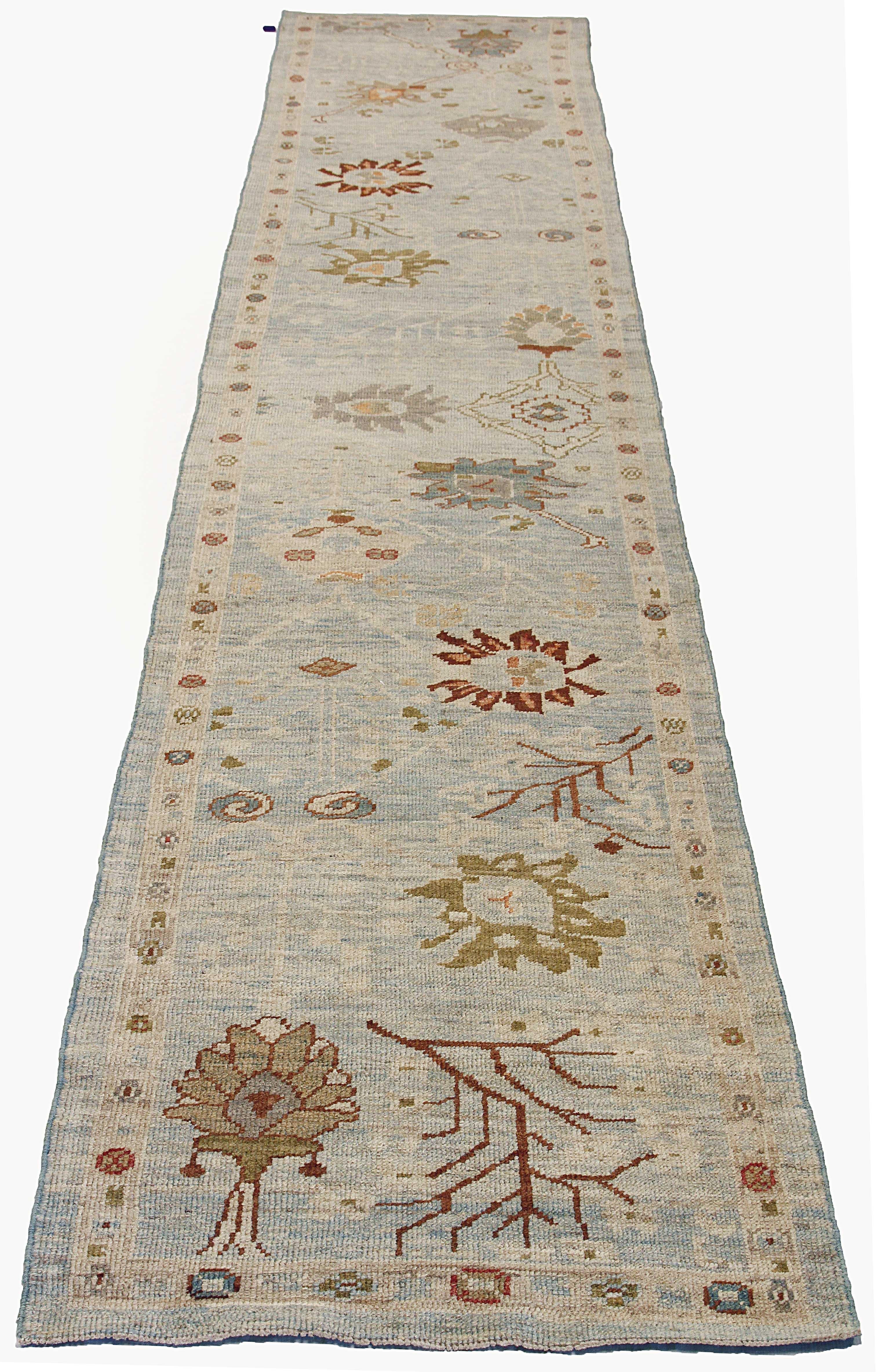 Contemporary Persian rug made of handwoven sheep’s wool of the finest quality. It’s colored with organic vegetable dyes that are certified safe for humans and pets alike. It features rows of flower medallion details all-over associated with Oushak