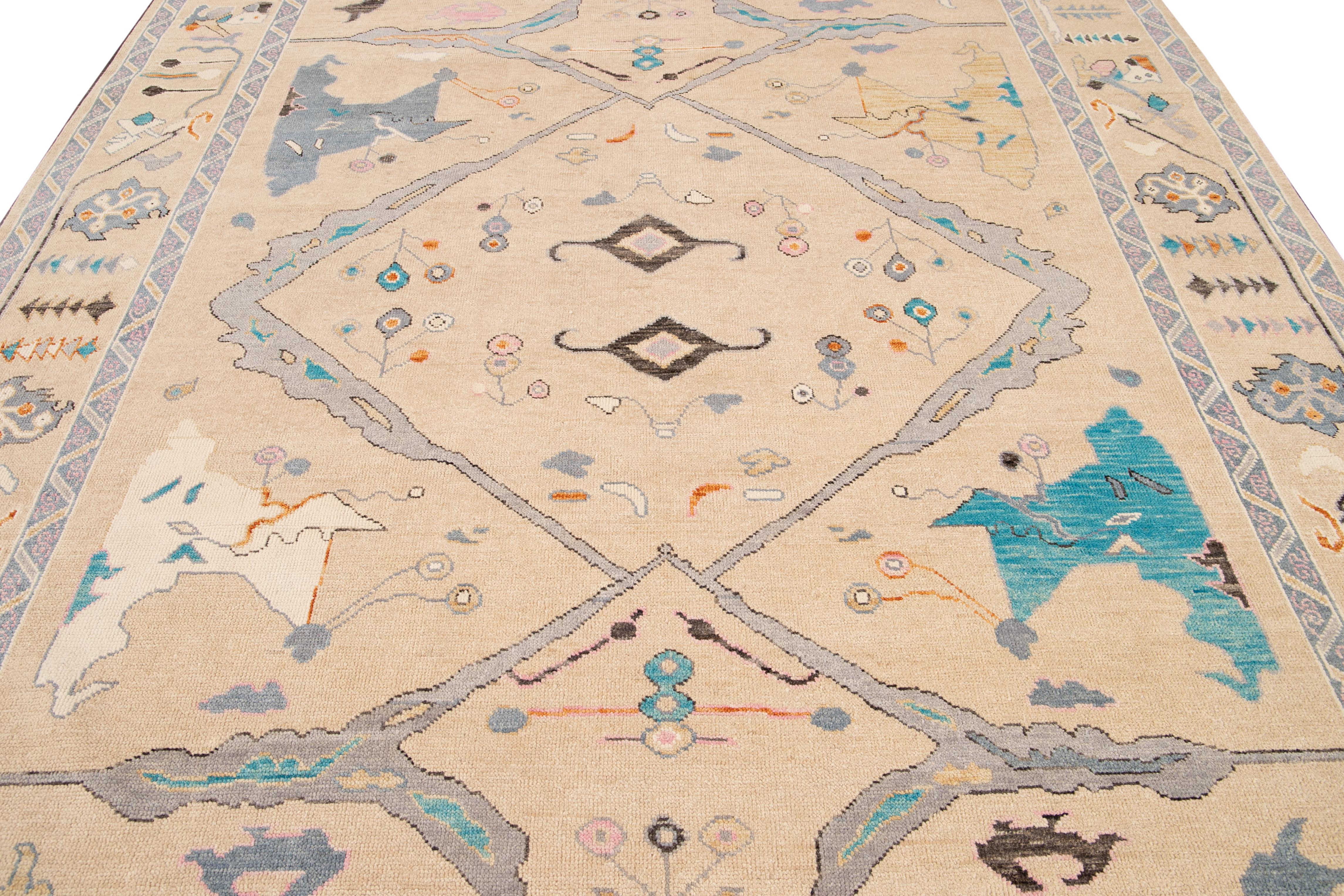 This exceptional Oversize Oushak Style wool rug features a charming gray color base and is hand-knotted with utmost attention to detail. With stunning beige accents, it displays a captivating floral pattern that is alluring to any décor.

This rug