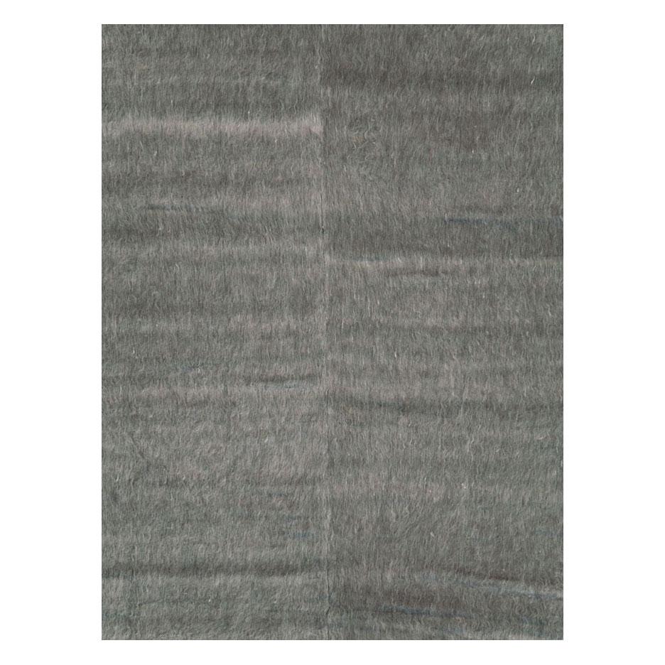 A modern Turkish Mohair room size carpet with a grey-colored long and lustrous pile from the 21st century in the style of minimalism. It may be used as a stand-alone piece or the foundation of a layered look.

Measures: 9' 11