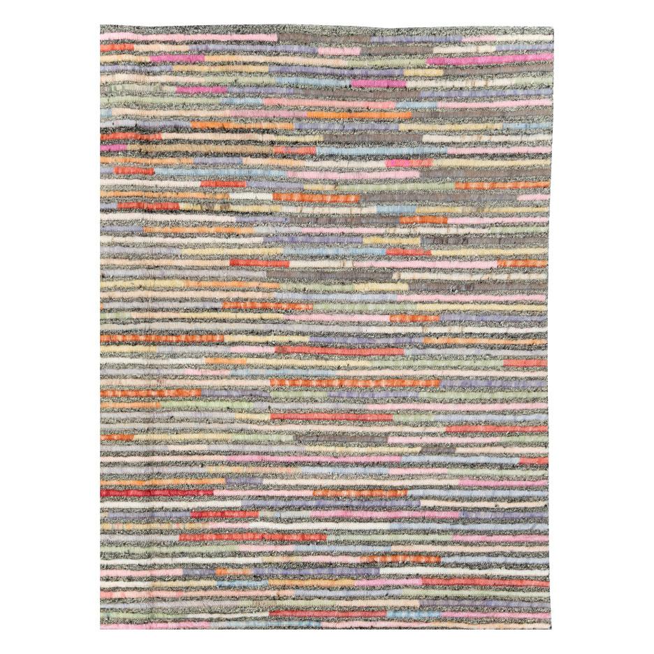 A modern Turkish room size carpet with a contemporary pattern consisting of colorful stripes over a salt and pepper ground handmade during the 21st century.

Measures: 8' 4