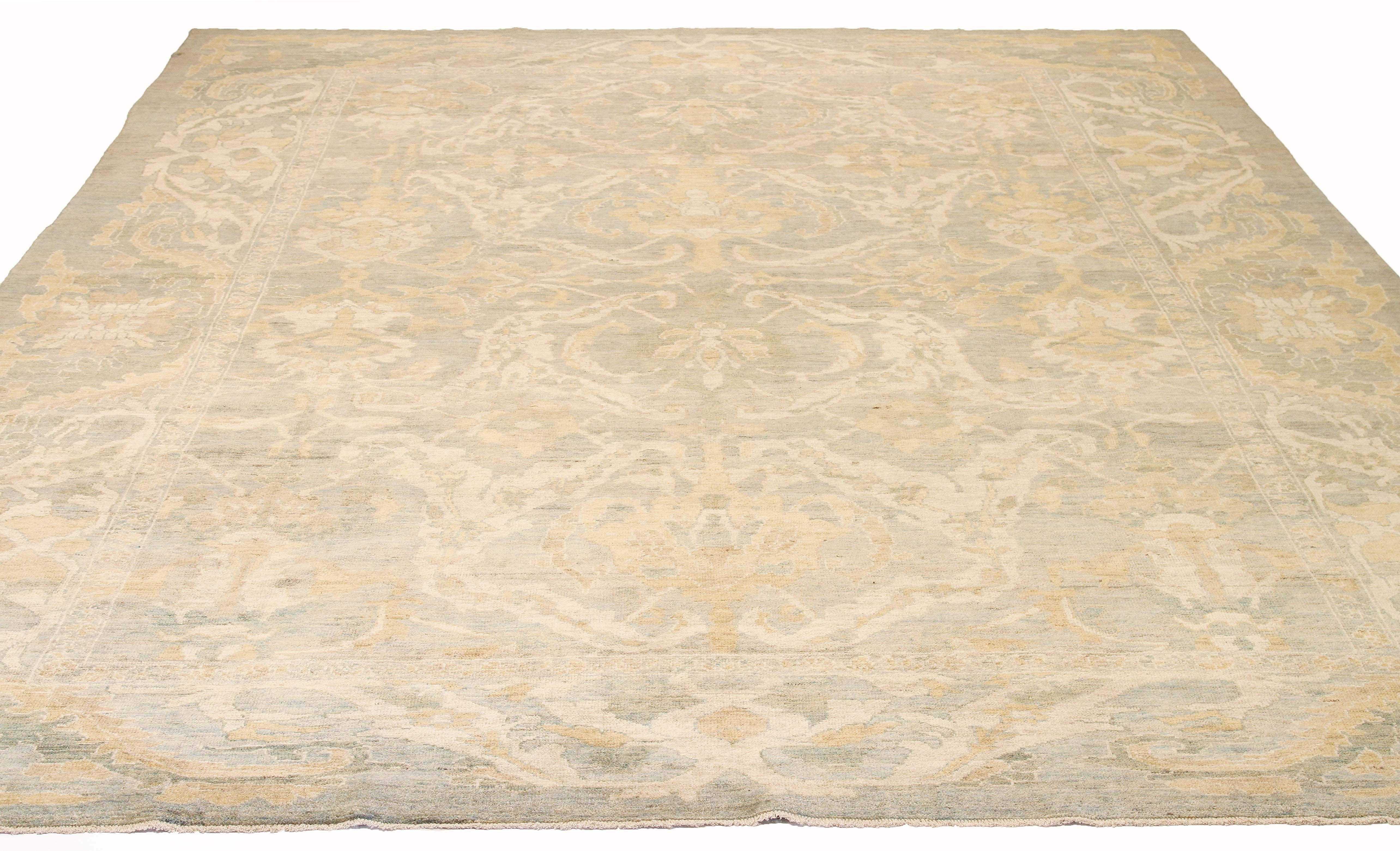 Modern handmade Turkish area rug from high-quality sheep’s wool and colored with eco-friendly vegetable dyes that are proven safe for humans and pets alike. It’s a contemporary Sultanabad design showcasing a regal gray field with prominent Herati