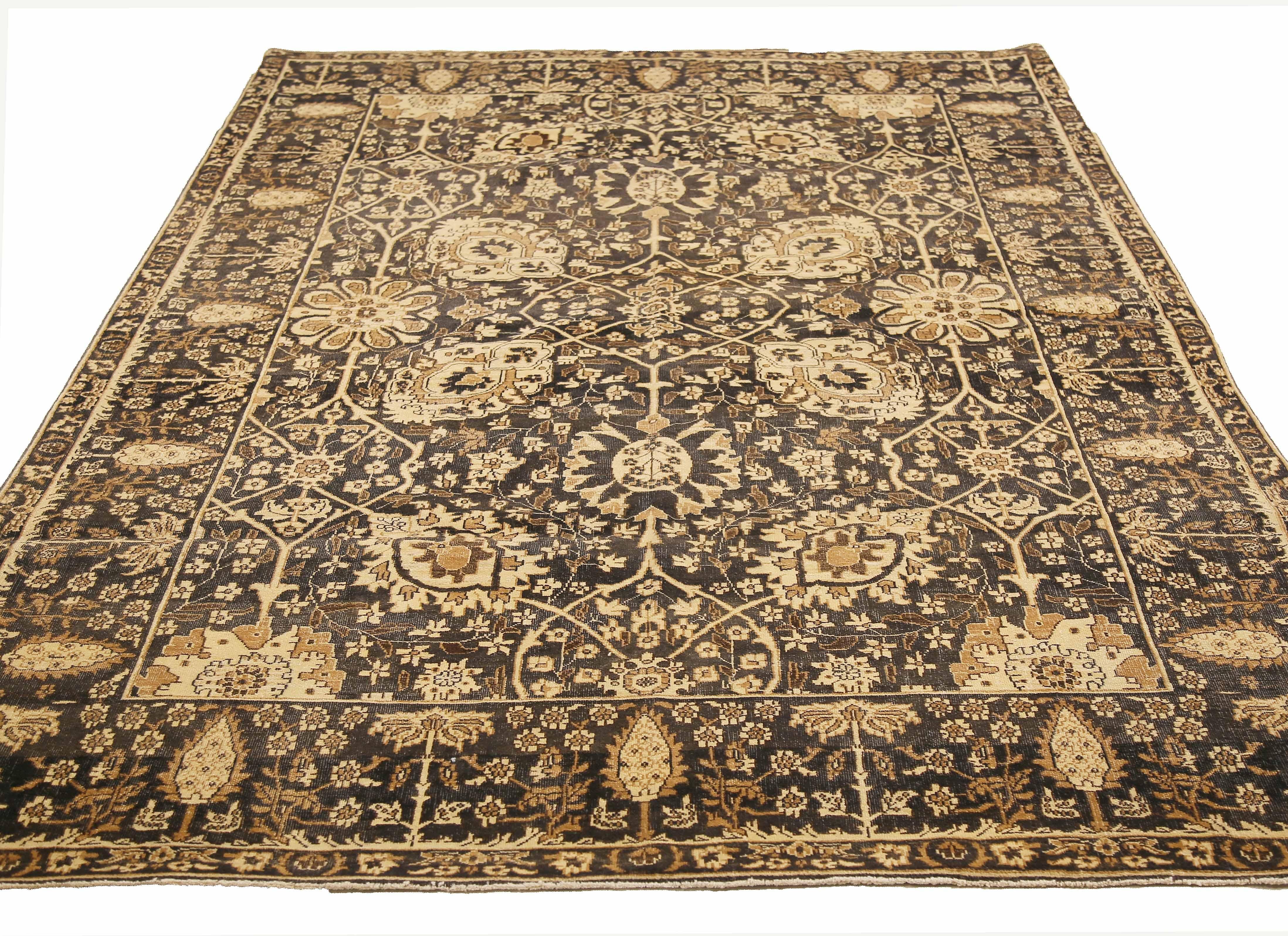 Contemporary Turkish rug handwoven from the finest sheep’s wool and colored with all-natural vegetable dyes that are safe for humans and pets. It’s a traditional Tabriz weaving featuring a lovely ensemble of floral designs in brown and ivory over a