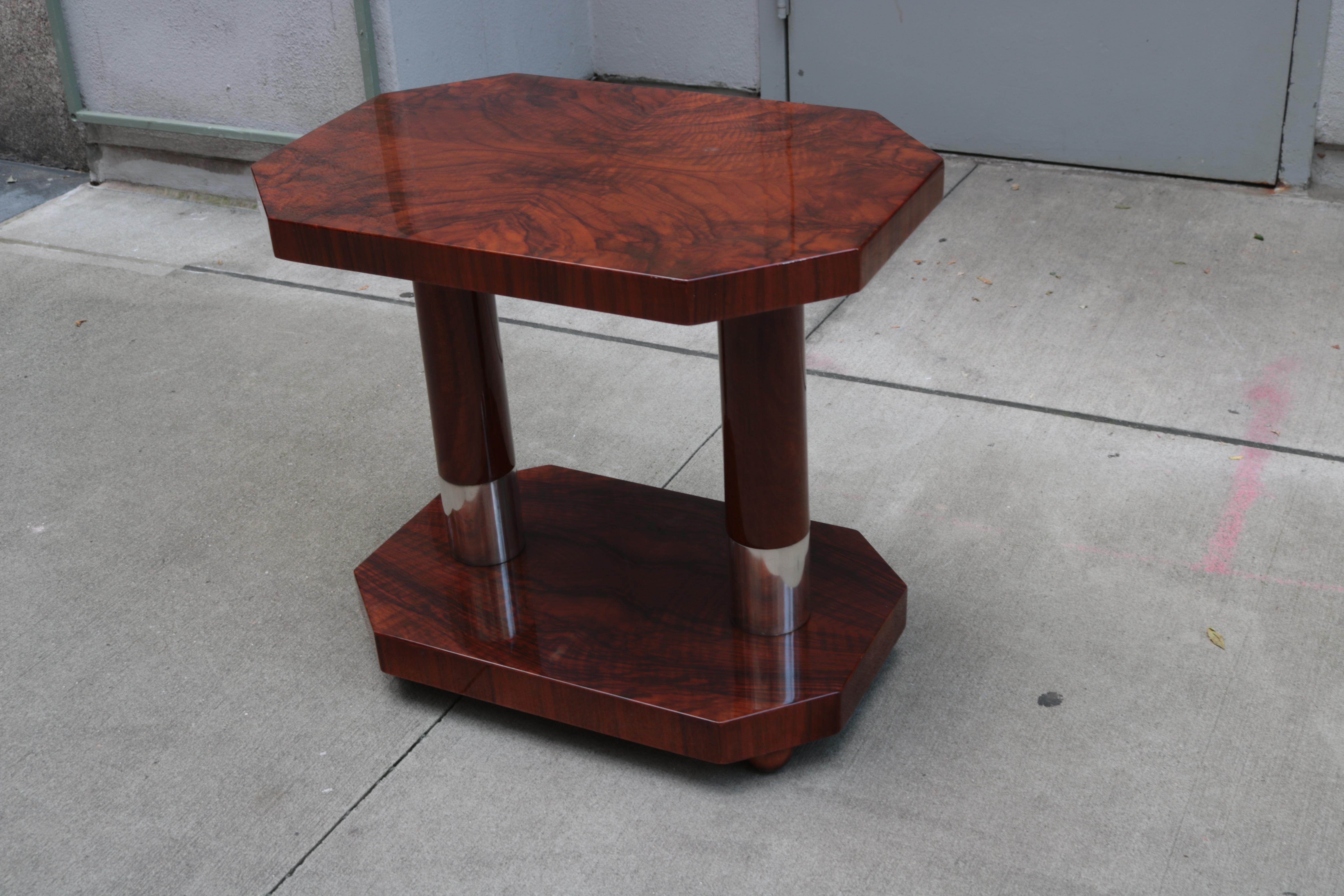 Contemporary two-tier side table with Art Deco inspired design.
Mahogany with nickel details.