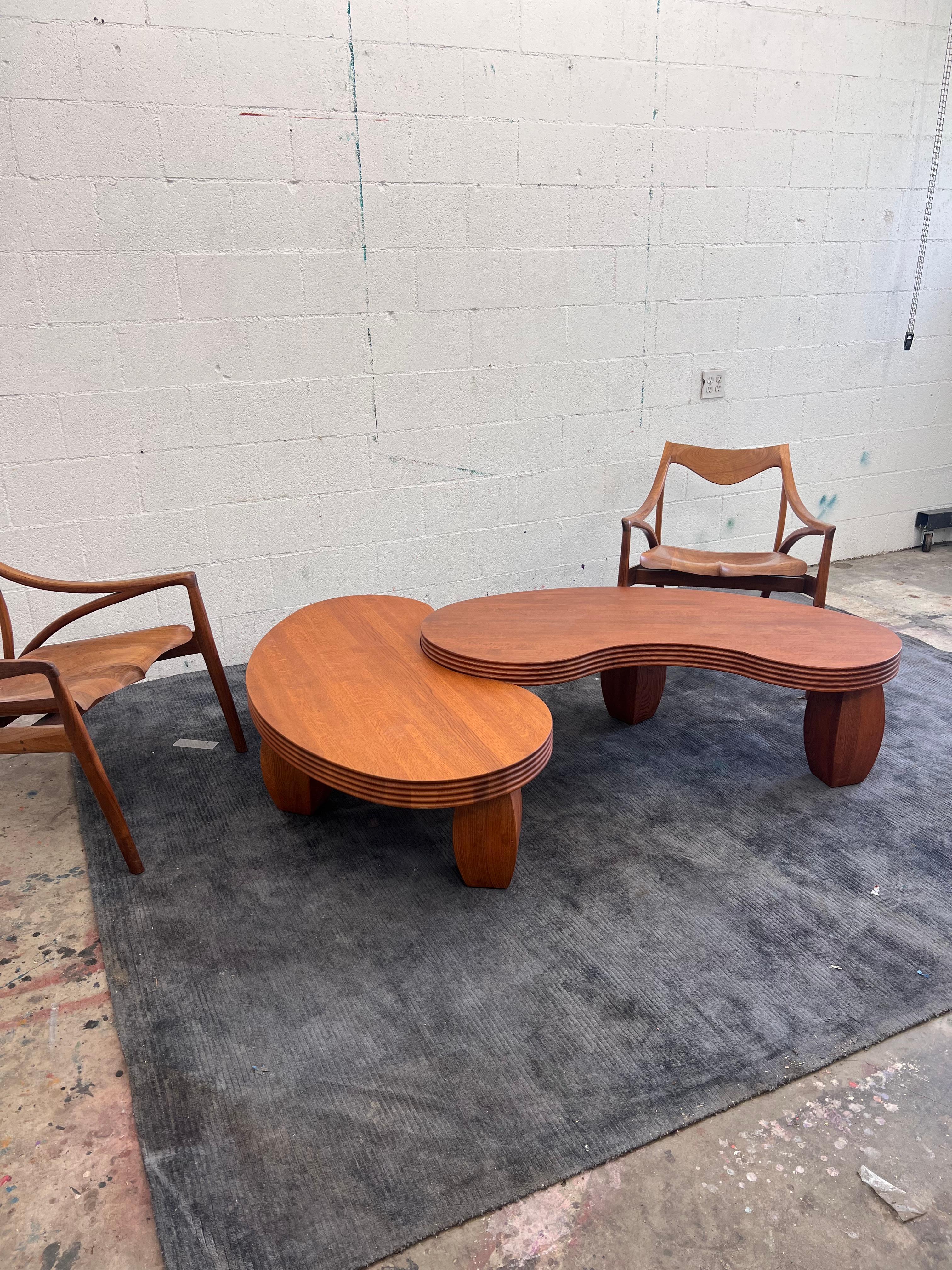A pair of large organic free-formed hand build solid American Red oak coffee tables. 
This pair can be positioned in numerous arrangements. 

Retails for $1,700 each or $3,400+ for the pair 

Extremely heavy weighing 90lbs each. The top slab is 2.8”