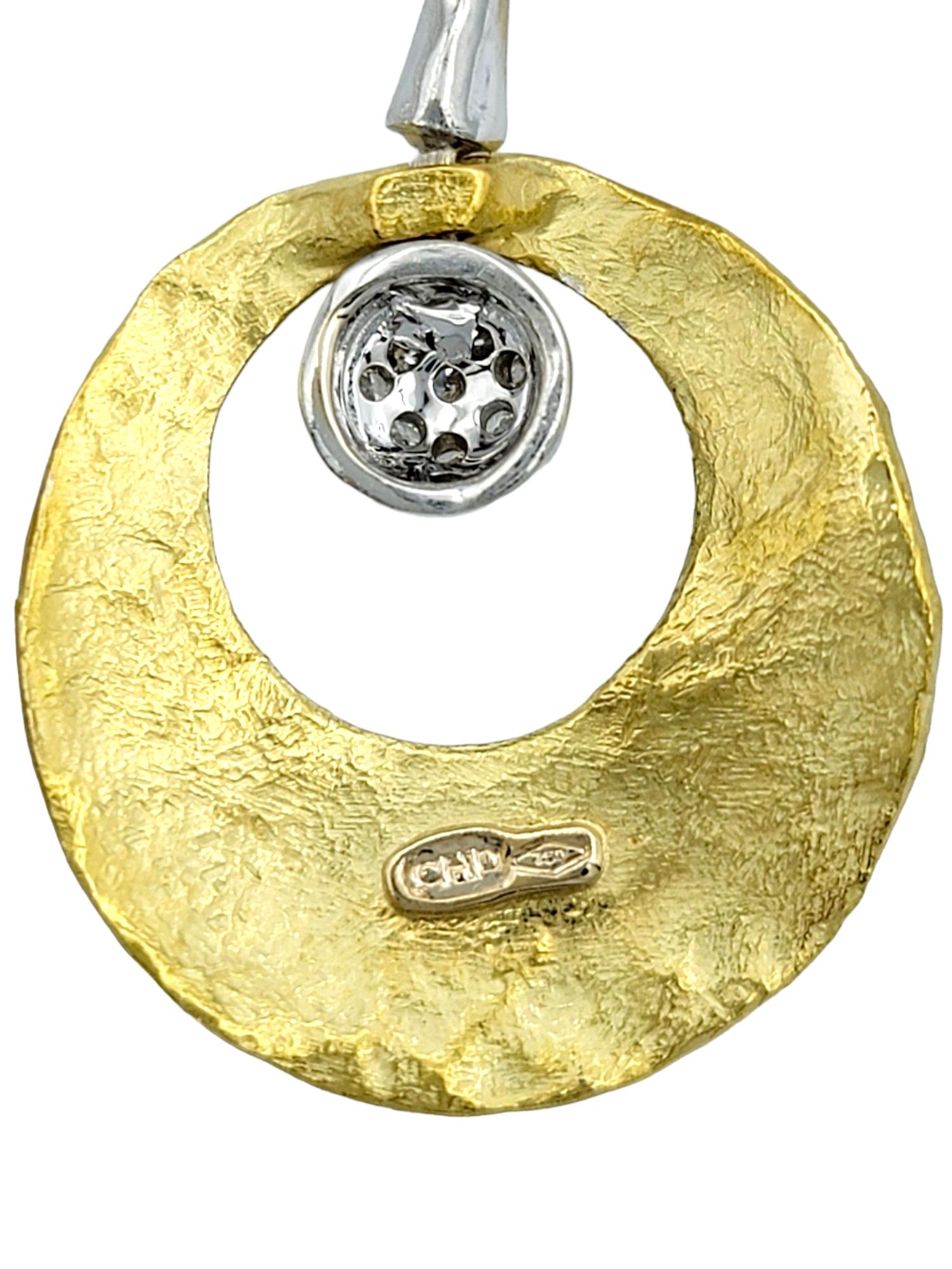 Embrace modern elegance with these contemporary two-toned 18 karat gold drop earrings. These exquisite earrings feature a striking design with hammered gold circles that catch the light beautifully, creating a captivating interplay of texture and
