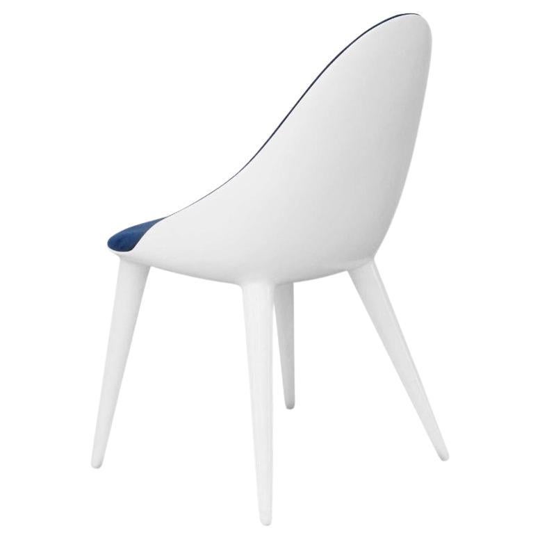 This chair is a sleek and stylish fiberglass chair that you can personalize with different finishes, colors, and fabrics. It's perfect for homes, hotels, and restaurants because of its classy design. The fiberglass makes it strong, and the velvet