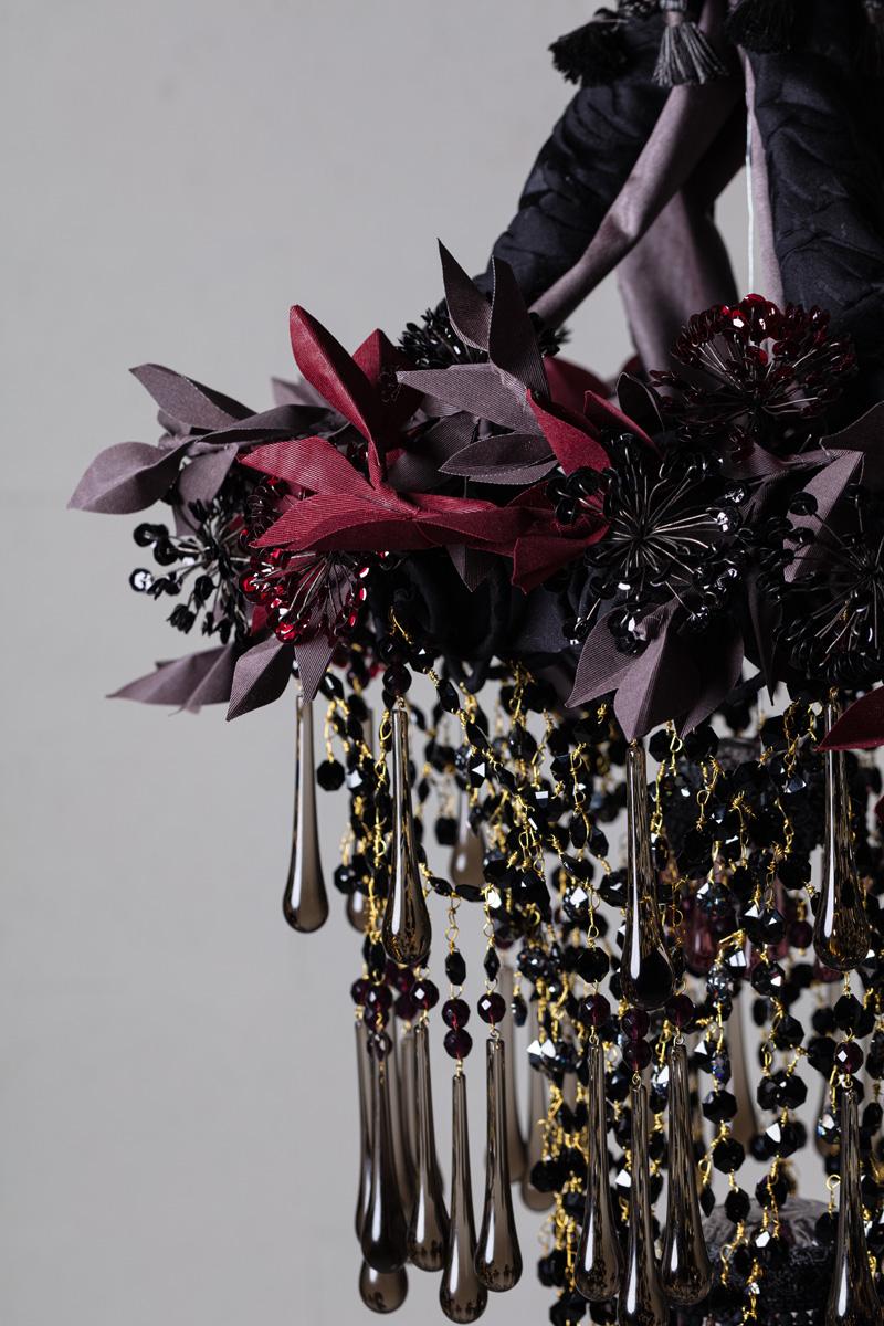 Iron Flowers Mignon

Iron Flowers Mignon chandelier. 
Iron structure covered in fabric, flowers decorations handmade with iron wire and sequins, fabric leaves made with hand waxed moiré fabric. 
The chandelier is completed by a cascade of