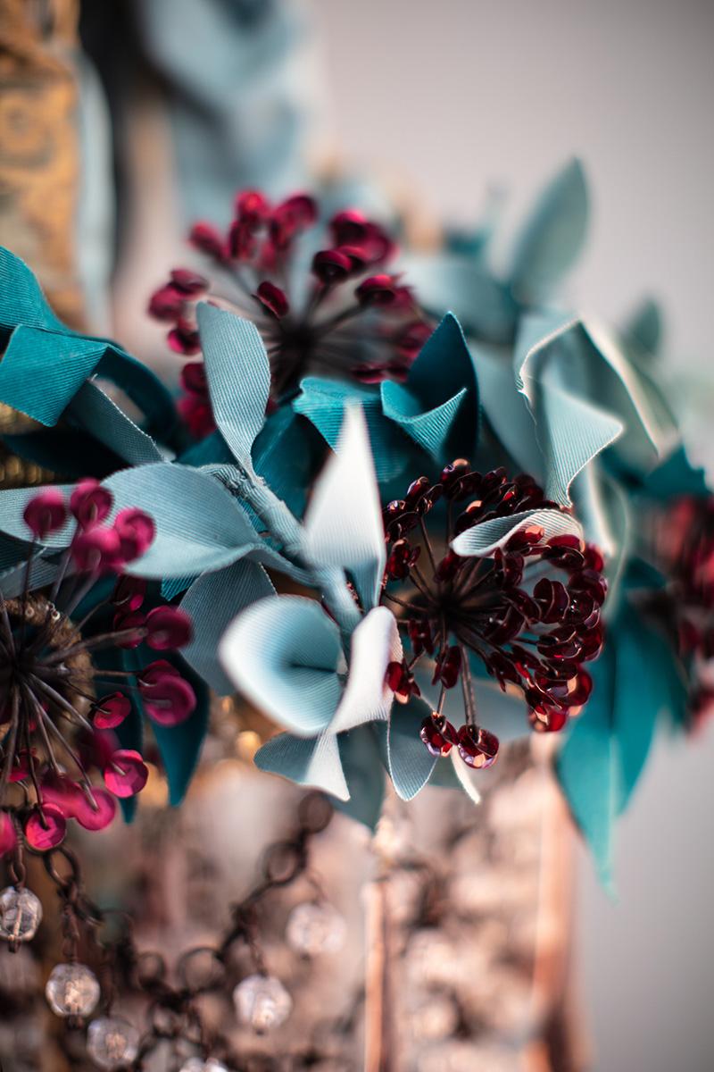 Iron Flowers Mignon

Iron Flowers Mignon chandelier. 
Iron structure covered in fabric, flowers decorations handmade with iron wire and sequins, fabric leaves made with hand waxed moiré fabric. 
The chandelier is completed by a cascade of