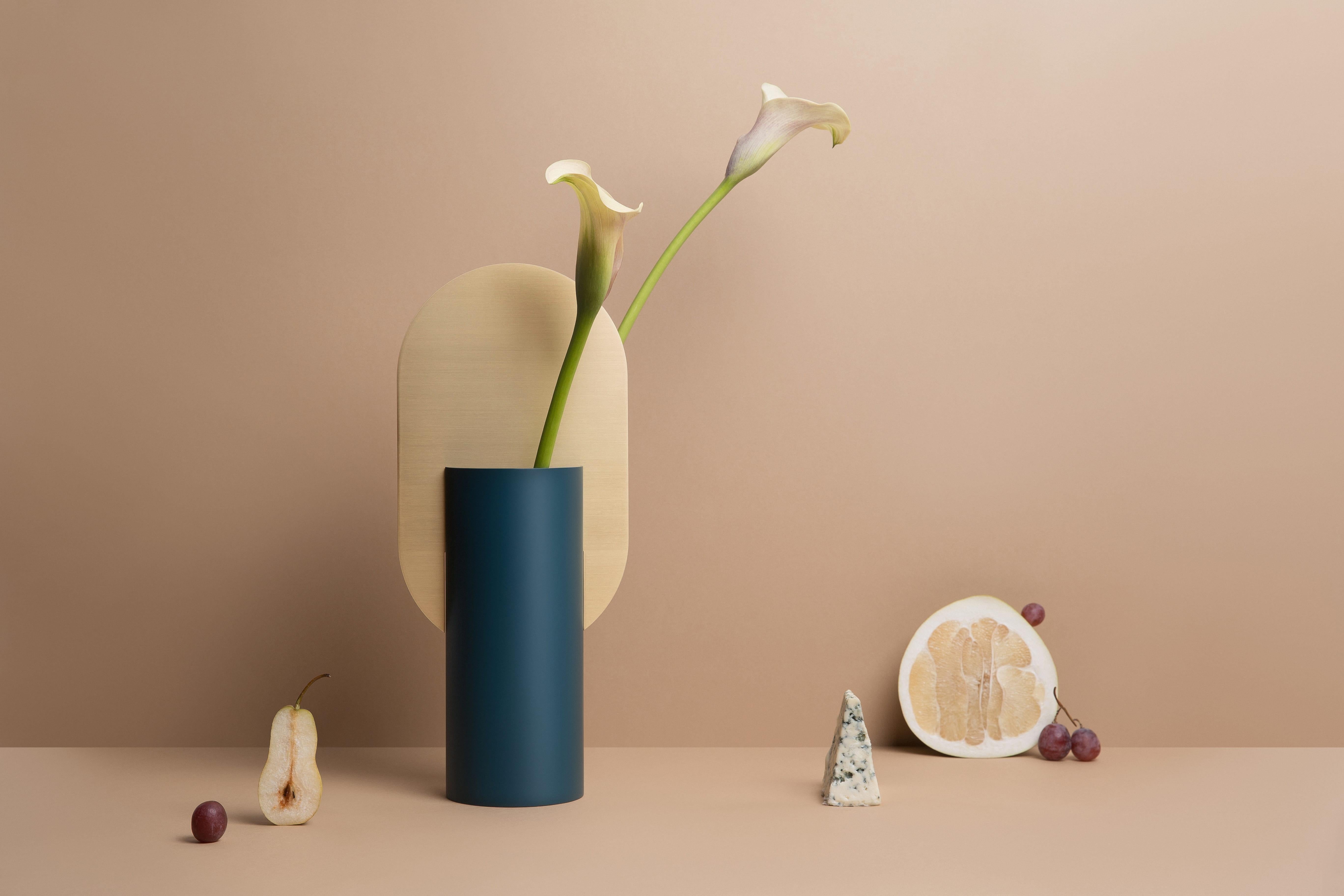Vase Genke CS3

Brand: Noom
Designer: Kateryna Sokolova
Materials: Brass, painted steel

Color Scheme: CS3 - ocean green and brass
Dimensions: H 38 cm x W 17 cm x D 10 cm

Net Weight: 2 kg.

Genke vase, one of the vases from the 
