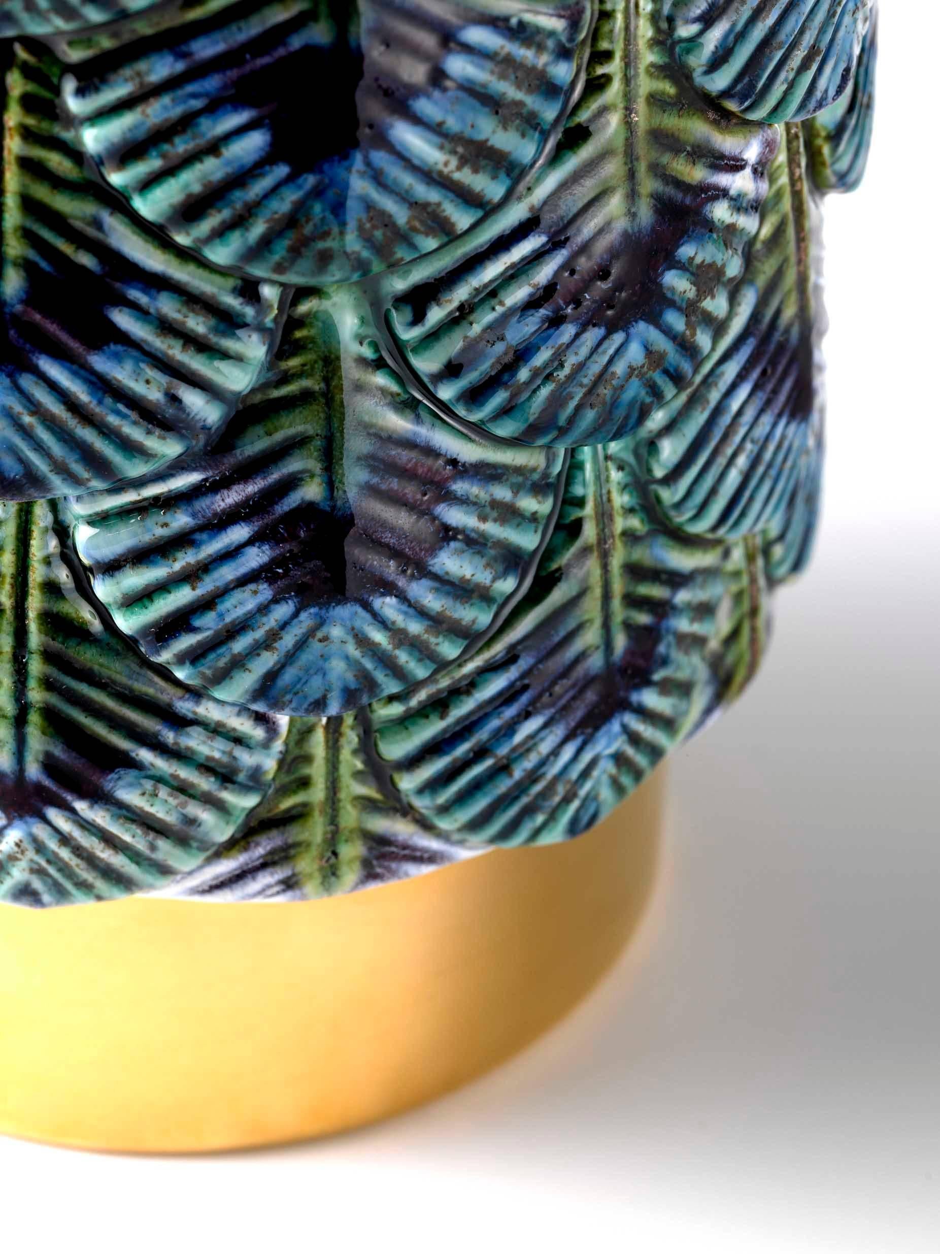 Plumage vase designed by Cristina Celestino for Botteganove is a ceramic vase produced with artisanal methods in Italy and hand-painted with deep violet, blue and green in order to imitate the colors of a peacock. The interior of the piece is violet